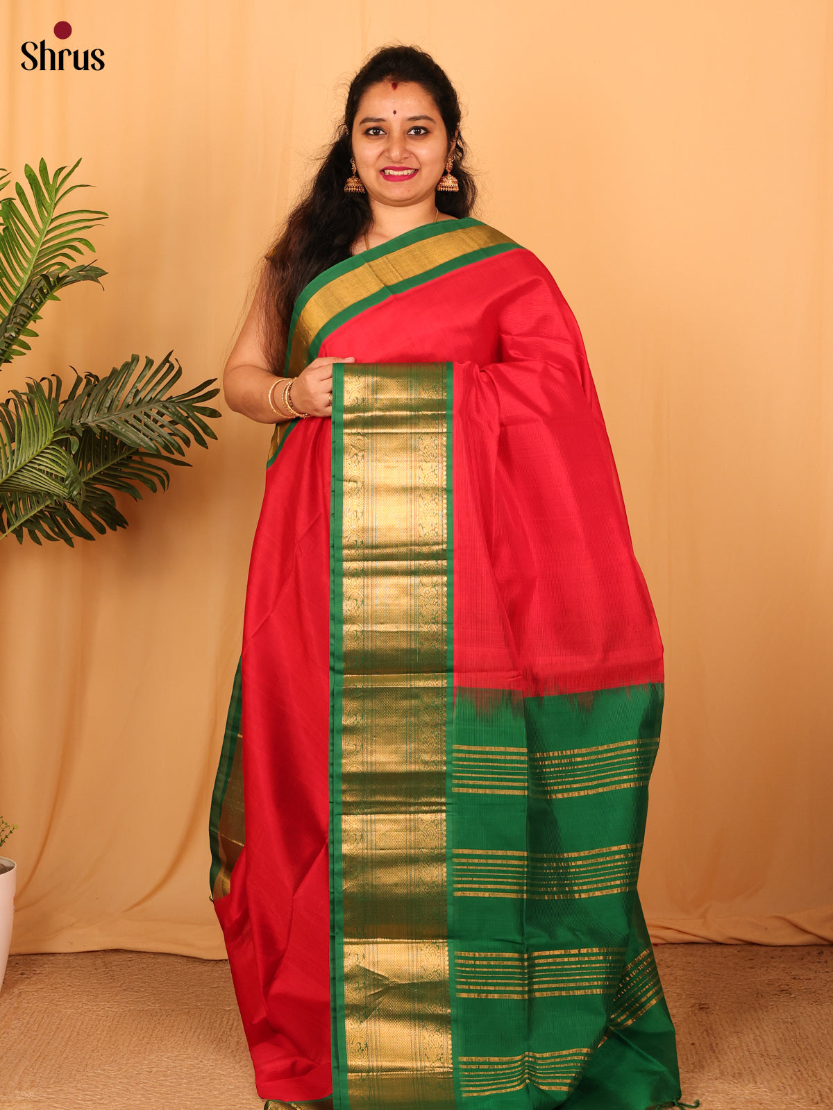 Majestic Red Silk Cotton Saree With Plain Body And Contrast Green Zari Woven Border With Small Peacock design
