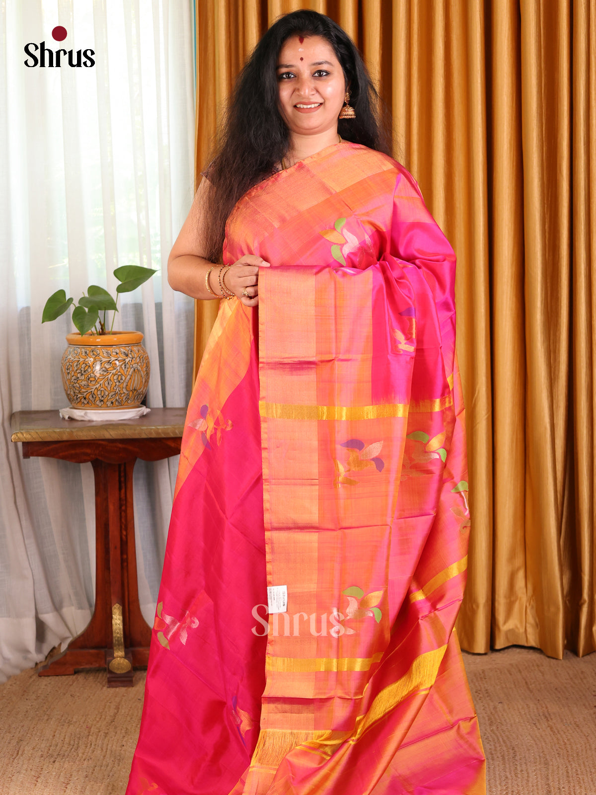 Deep Pink Uppada silk Saree with zari woven floral motifs paired with contrast pallu