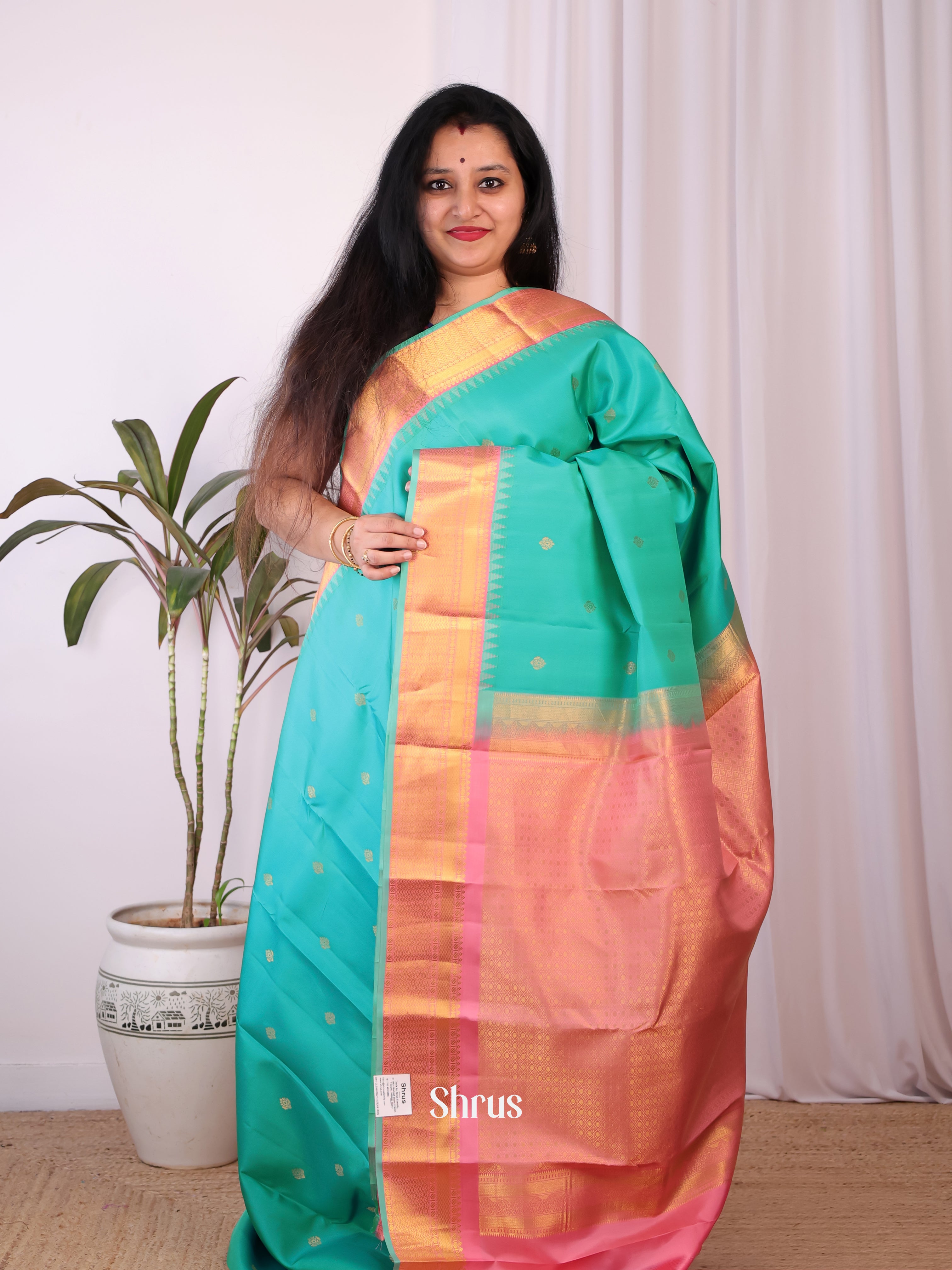 Teal and Pink Pure Kanchipuram silk Saree Adorned With Intricate Zari Woven Floral Buttas-1