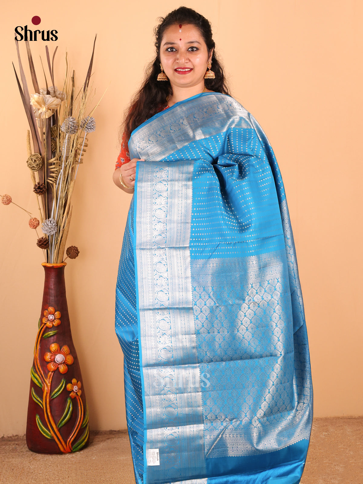 Sophisticated Blue Monochrome Kanchipuram silk Saree with zari buttas & floral pallu - Shop on Shrus.com