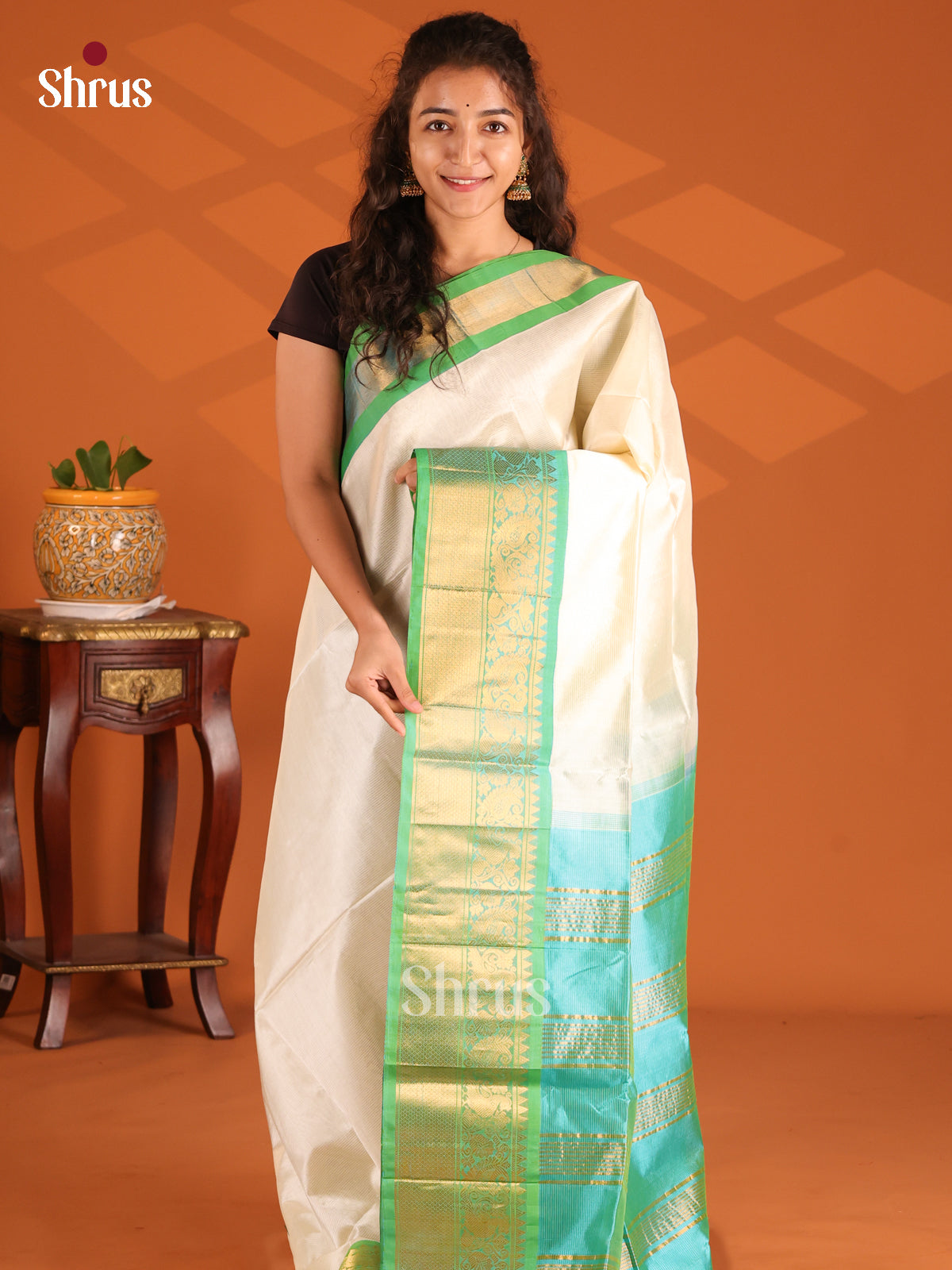 Charming Cream Silk Cotton Saree with contrast teal green border with peacock floral vines - Shop on Shrus.com