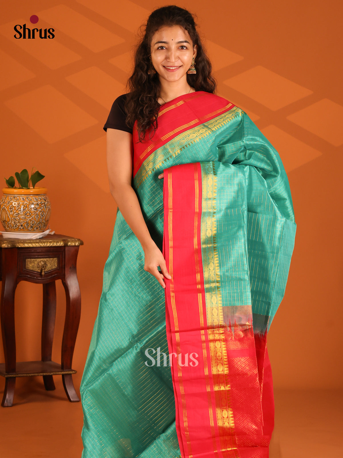 Chic Green Silk Cotton Saree Accented with Gold Checks & Red Border