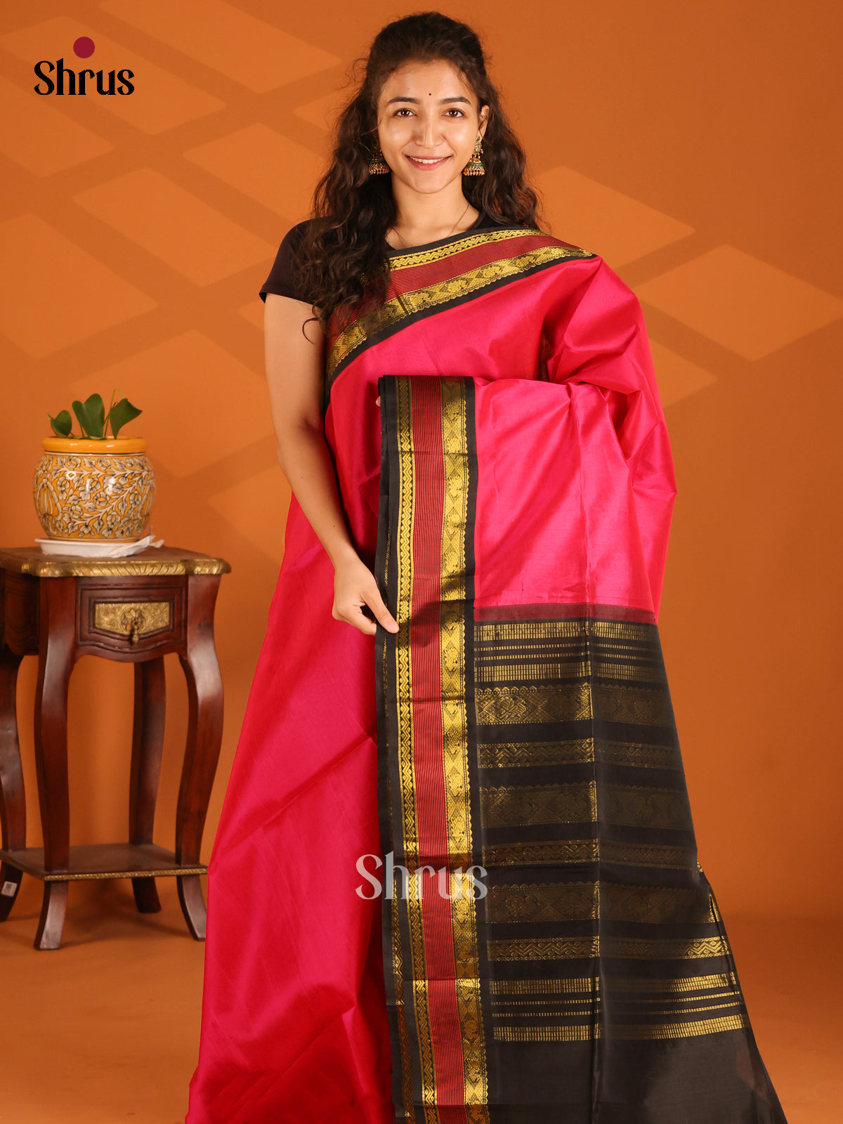Lustrous Pink Silk Cotton Saree with plain body & black zari border