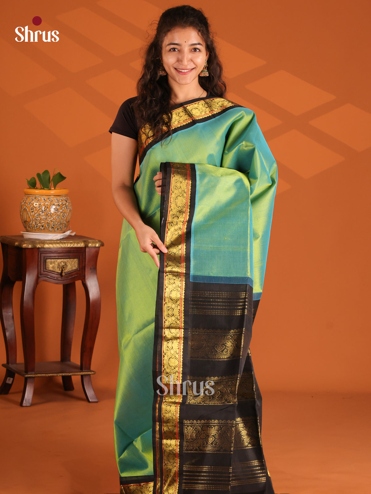 Shimmery Green Silk Cotton Saree with floral vines in black border - Shop on Shrus.com