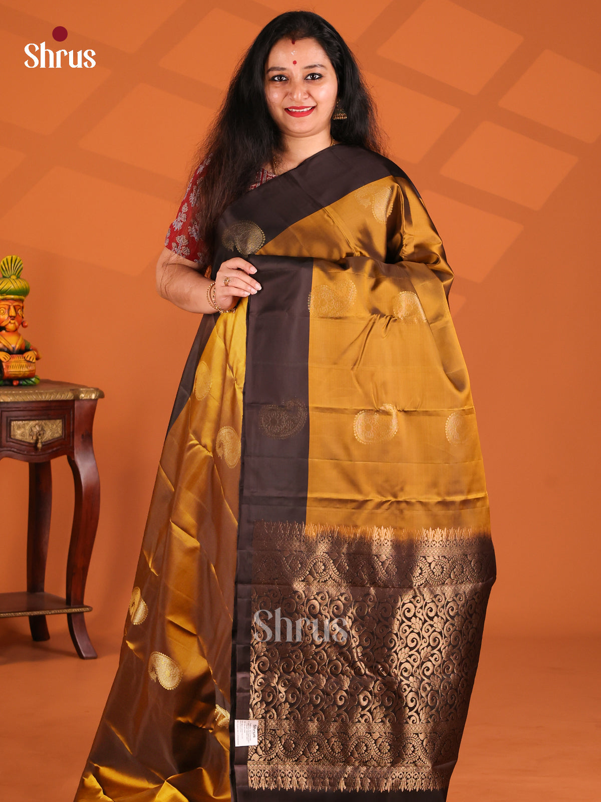 Bright Mustard Softsilk-halfpure Saree gleams with gold zari paisleys motifs