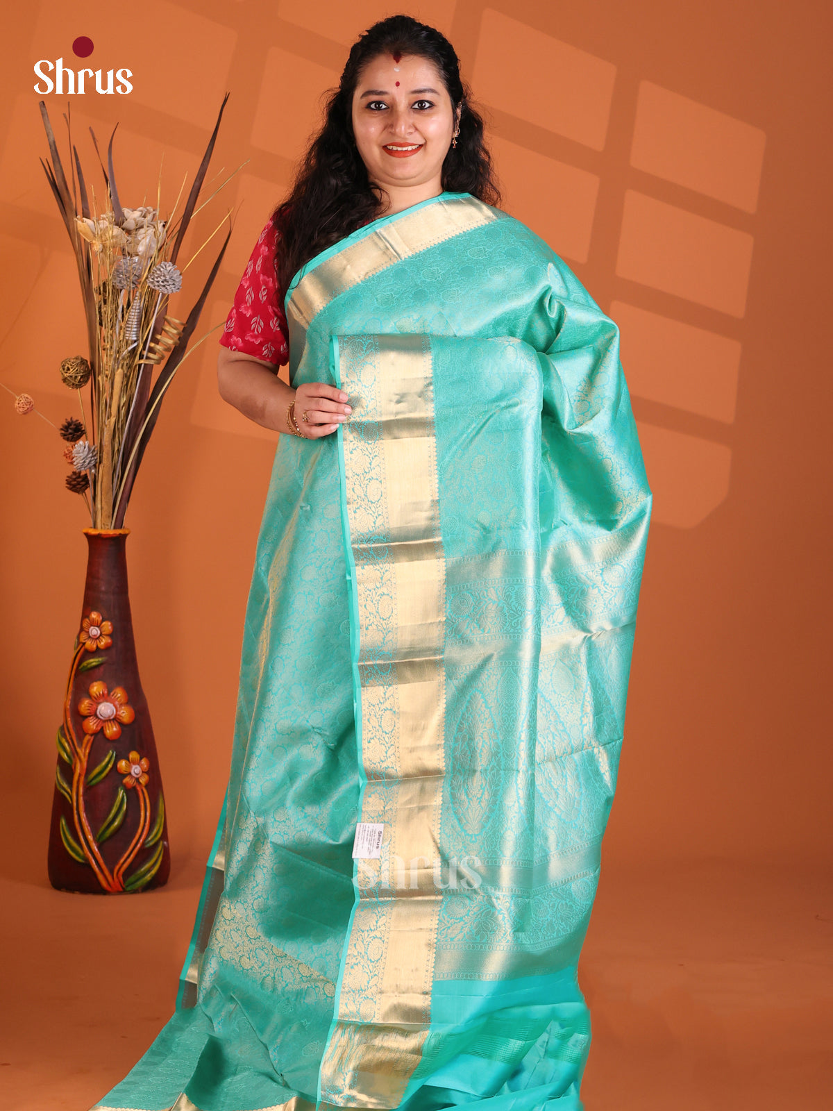 Turquoise monochrome Kanchipuram silk Saree with floral brocade