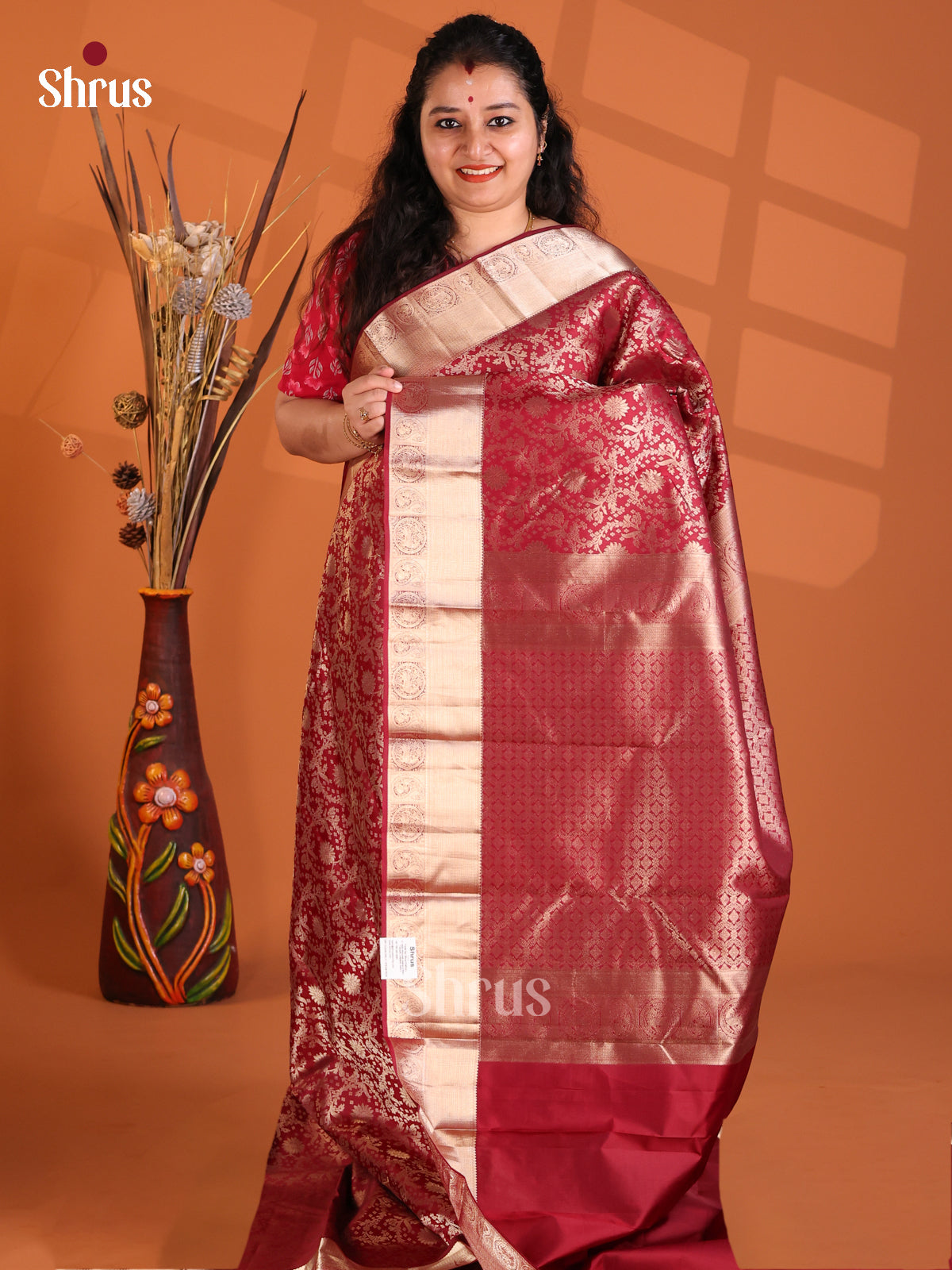 Classy Maroon Single Tone Kanchipuram silk Saree with floral nestling Brocade