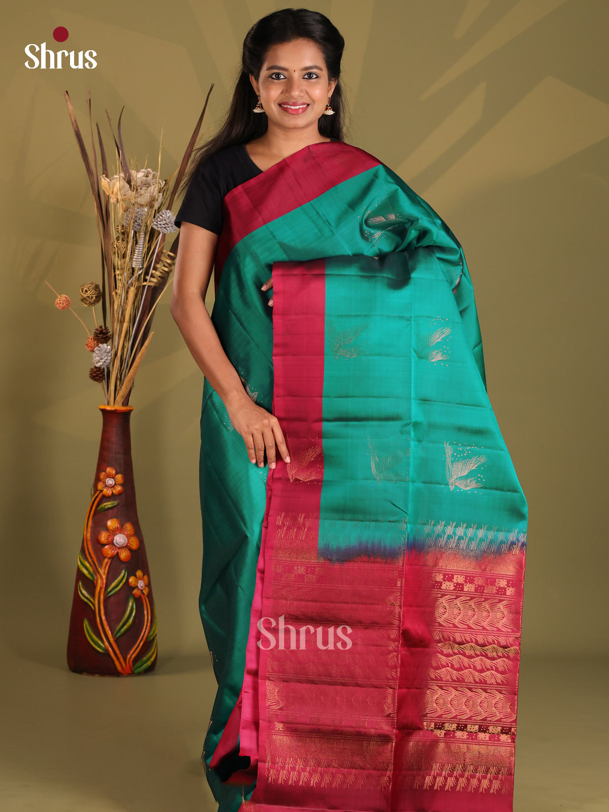 Elegant Green & Maroon Softsilk-halfpure Saree gleams with zari motifs