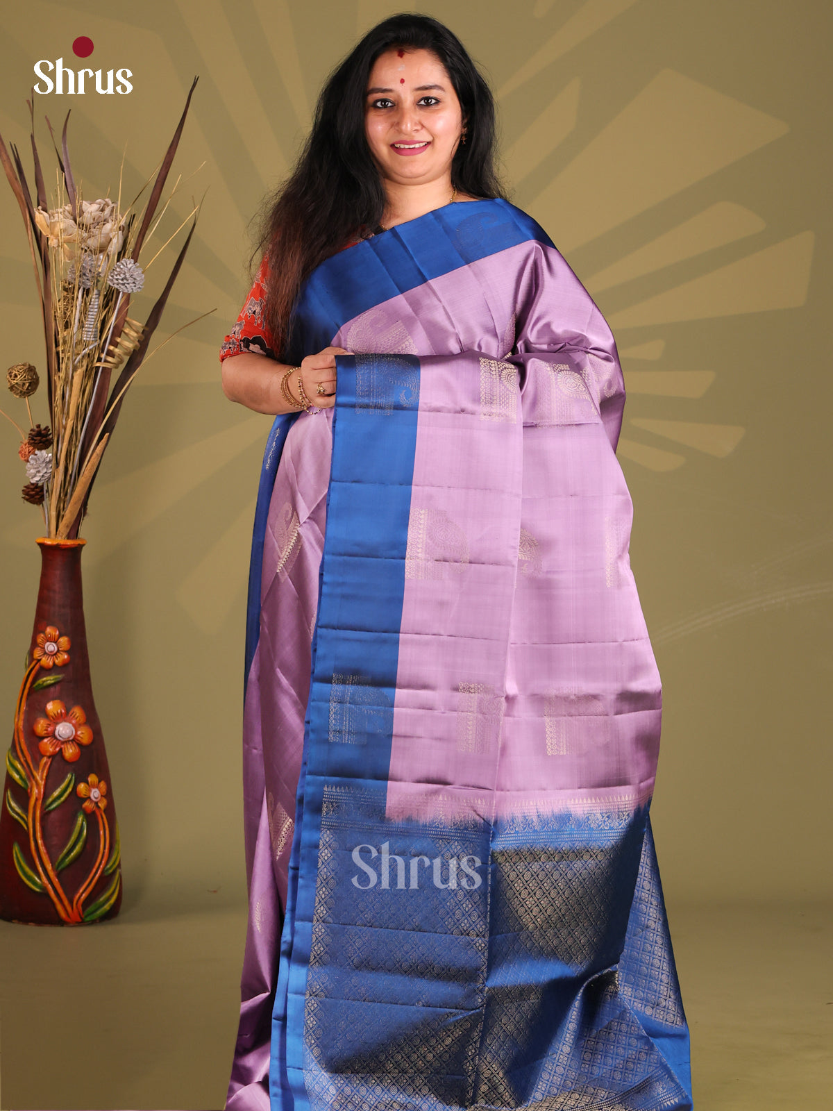 Lustrous Lavender & Blue Softsilk-halfpure Saree gleams with zari motifs
