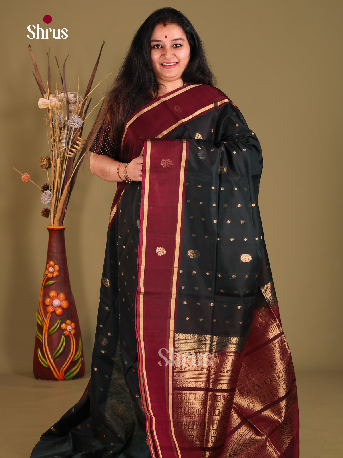 Dark Green & Maroon Silk Cotton Saree gleams wih gold zari floral buttas