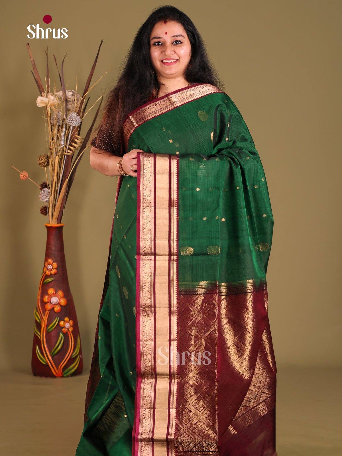 Green & Maroon Silk Cotton Saree gleams with gold zari peacock buttas - Shop on Shrus.com