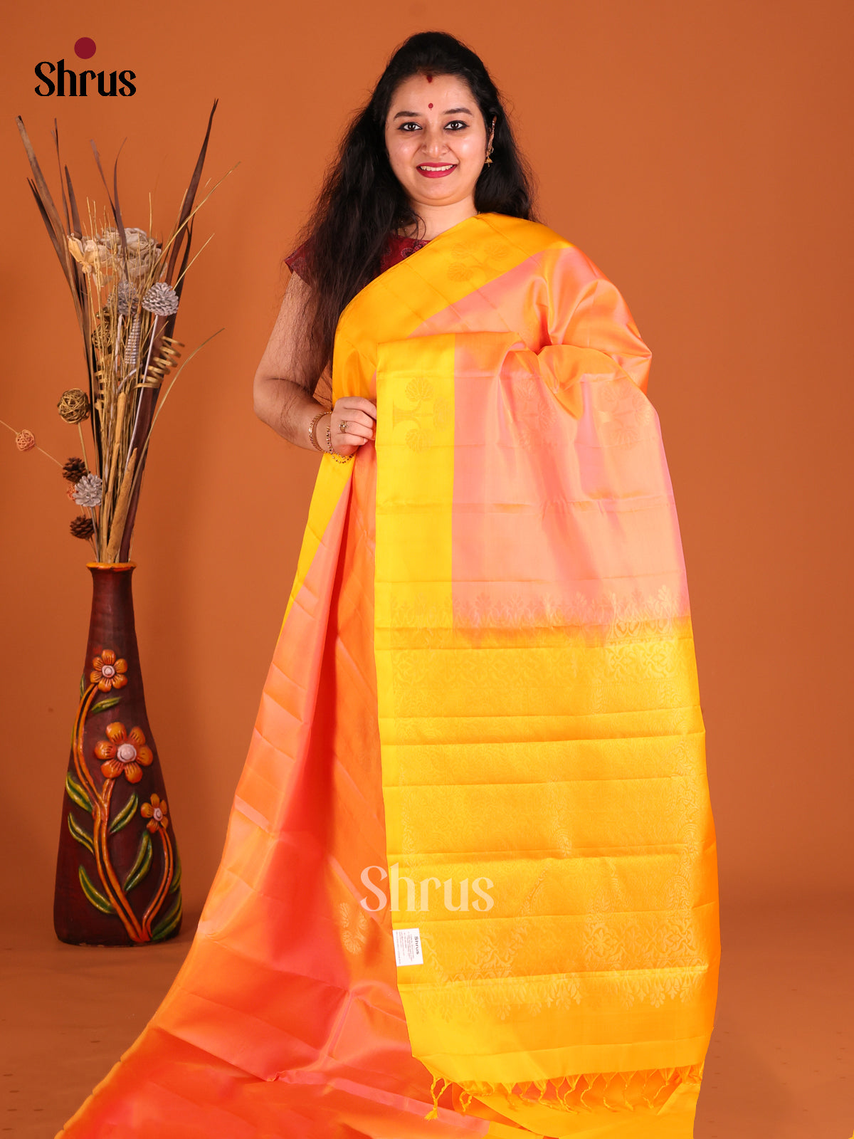 Peach & yellow Softsilk-halfpure Saree gleams with zari floral motifs