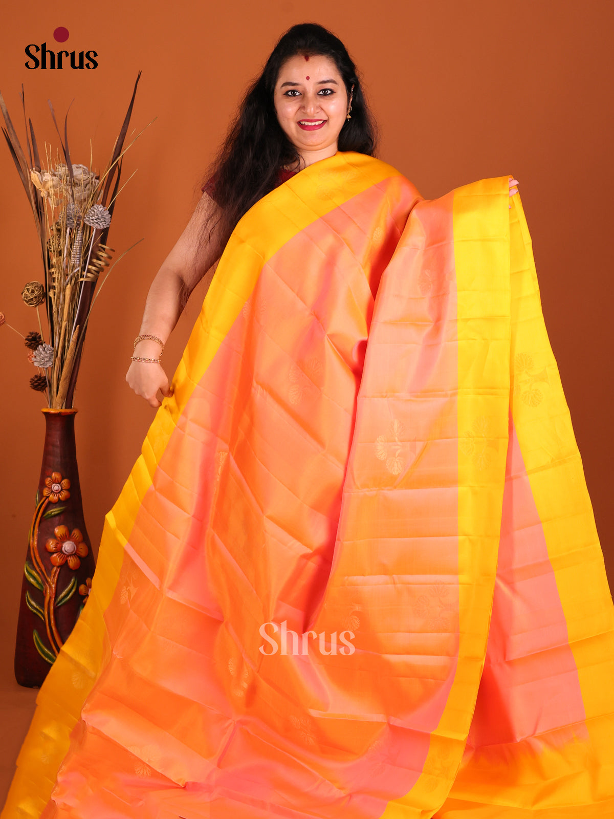 Peach & yellow Softsilk-halfpure Saree gleams with zari floral motifs