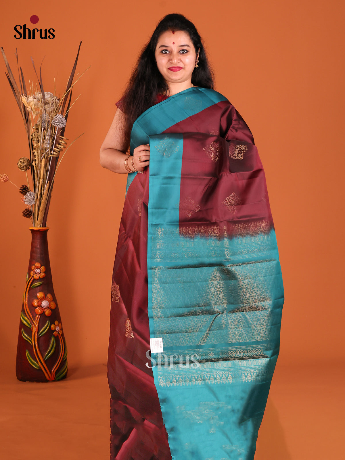 Maroon & Blue Softsilk-halfpure Saree gleams with gold zari floral motifs