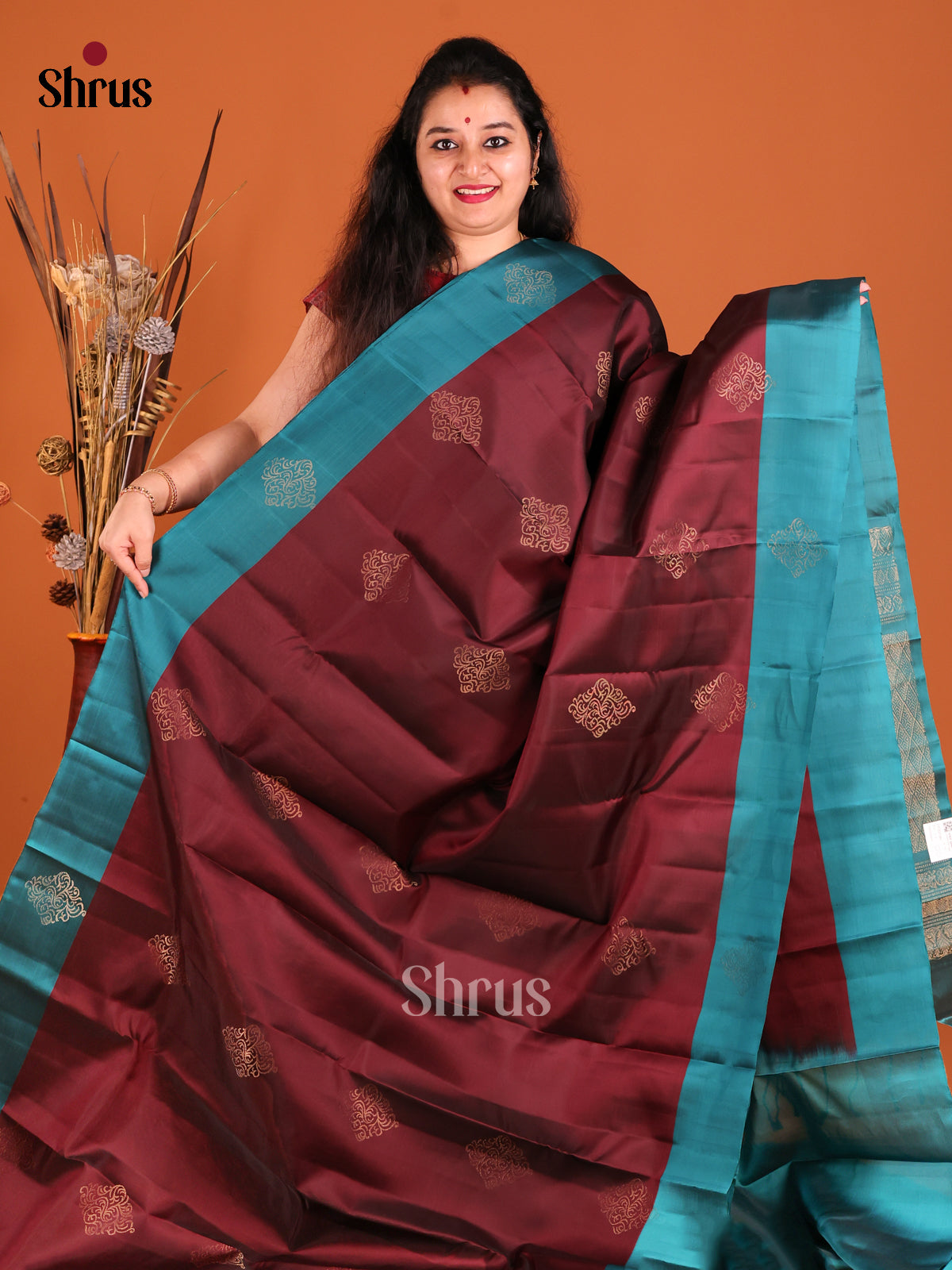 Maroon & Blue Softsilk-halfpure Saree gleams with gold zari floral motifs