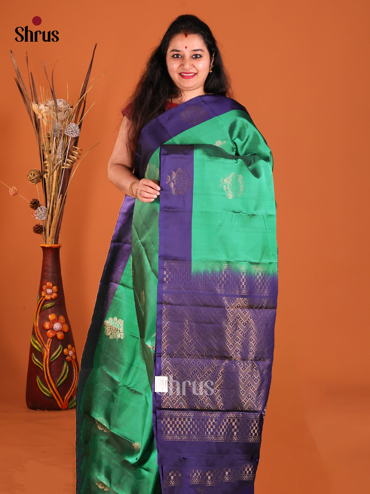 Green & Blue Softsilk-halfpure Saree gleams with zari floral motifs