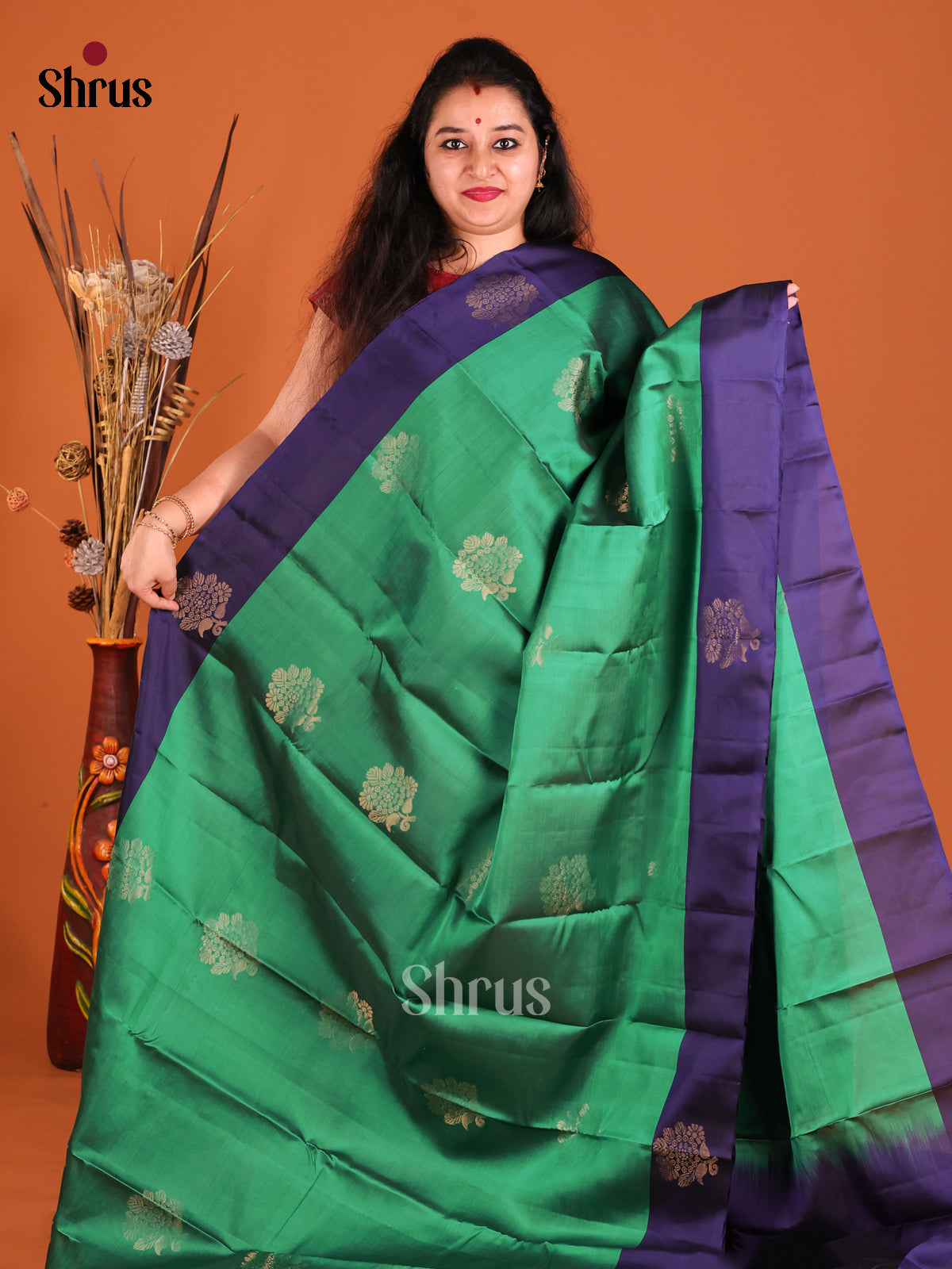 Green & Blue Softsilk-halfpure Saree gleams with zari floral motifs