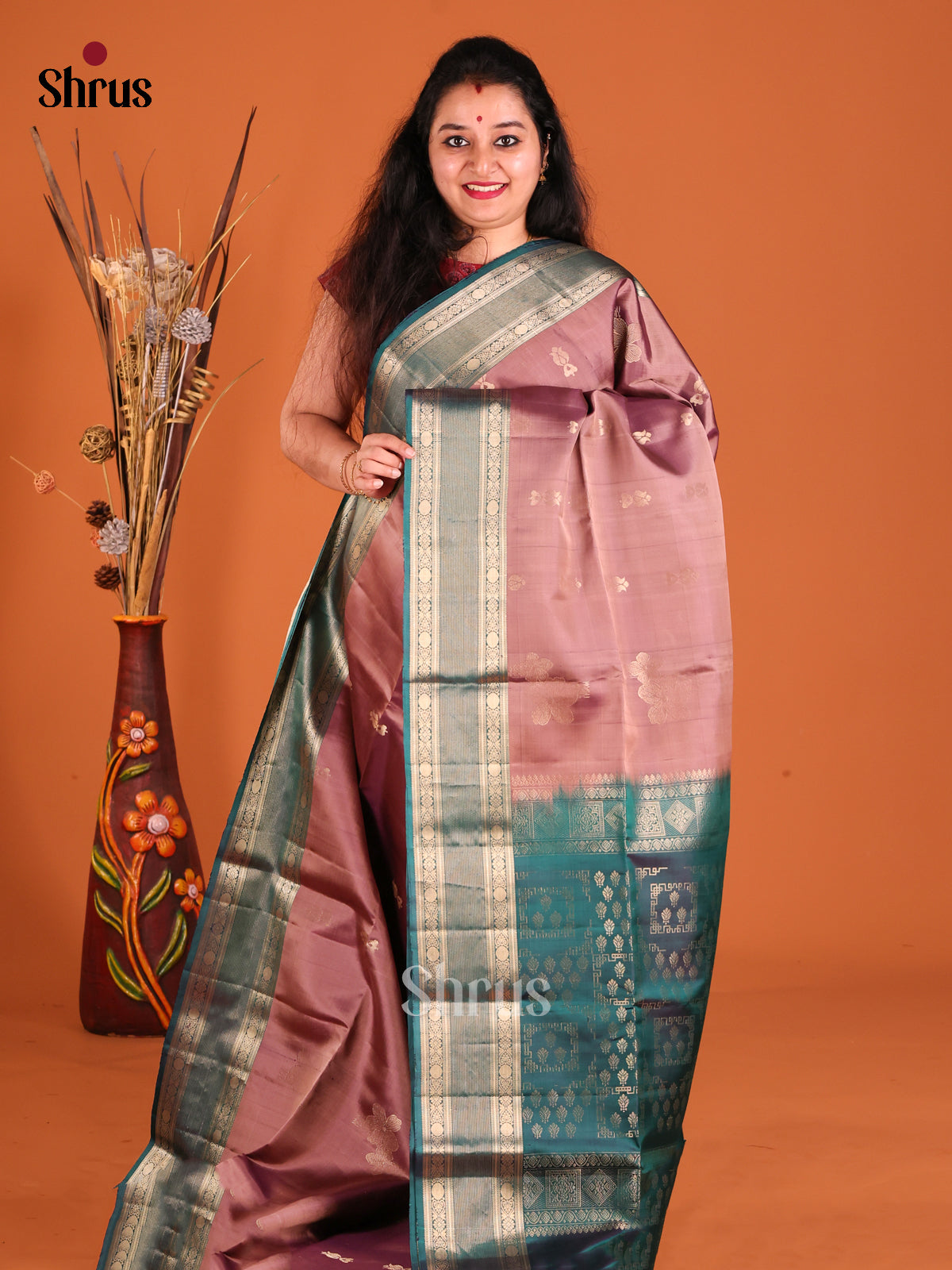 Onion Peel & Peacock Green Soft Silk Saree gleams with gold zari buttas