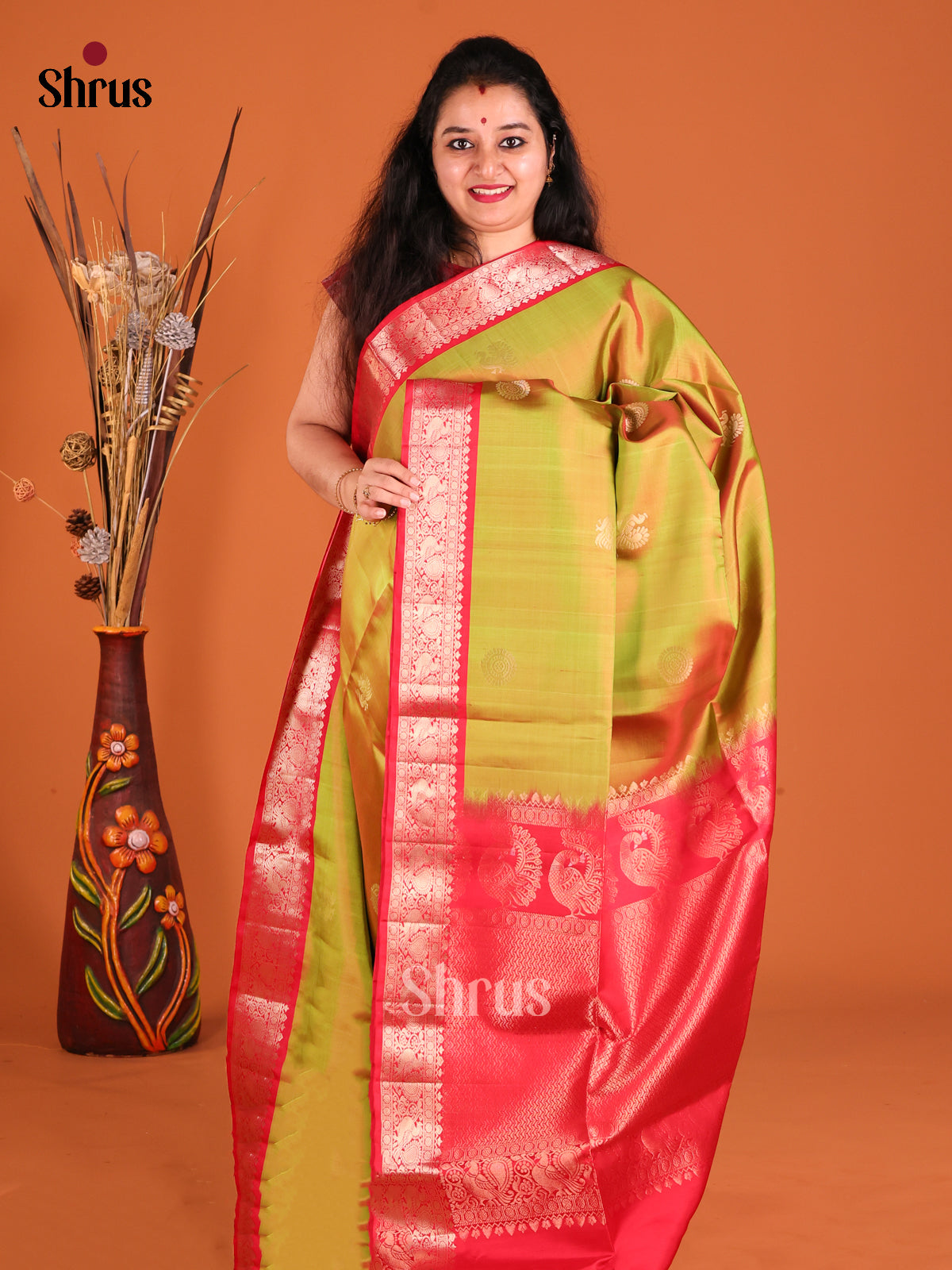 Serene Green Soft Silk Saree gleams with peacock , floral buttas