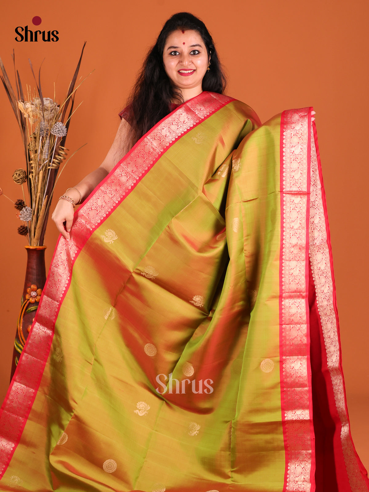 Serene Green Soft Silk Saree gleams with peacock , floral buttas