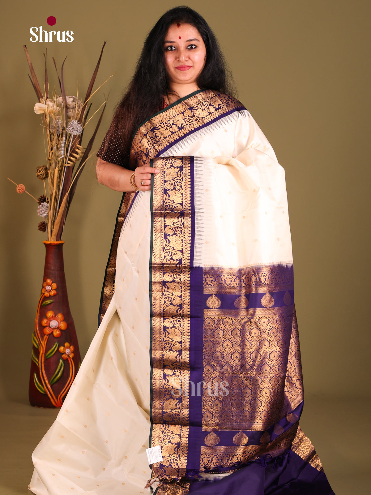 Lustrous Cream Gadwal silk Saree with Gold Buttas & Navy Blue floral vines zari border