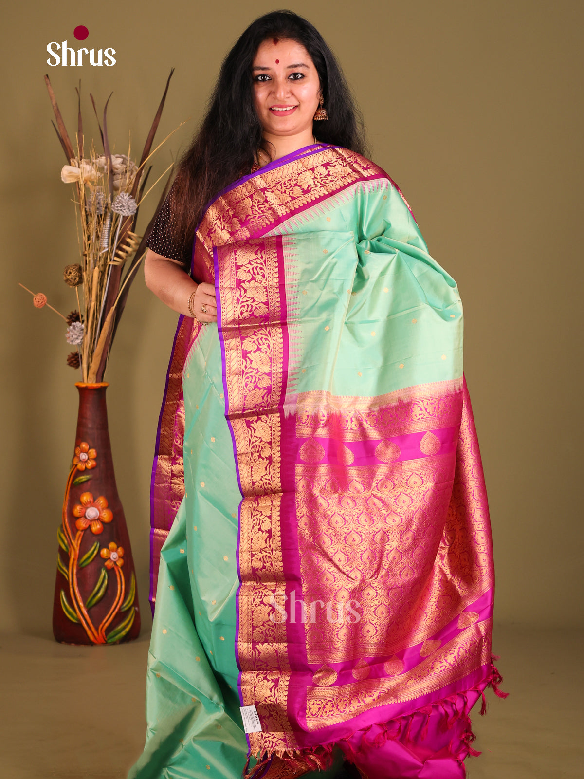 Elegant Teal Green Gadwal silk Saree with Magenta floral vines zari border