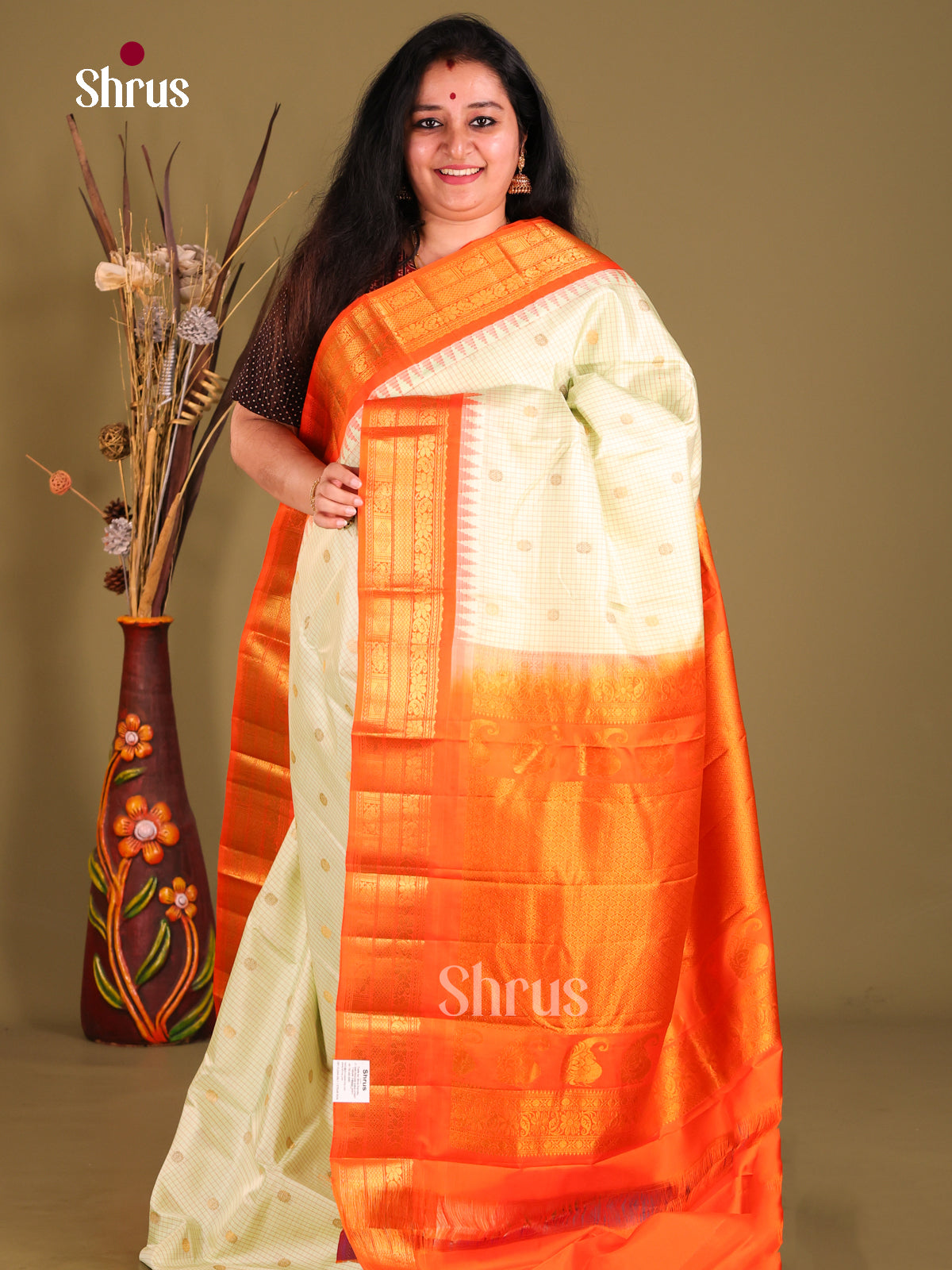 Subtle Cream Gadwal silk Saree with intricate checks, floral buttas & Orange Zari Border
