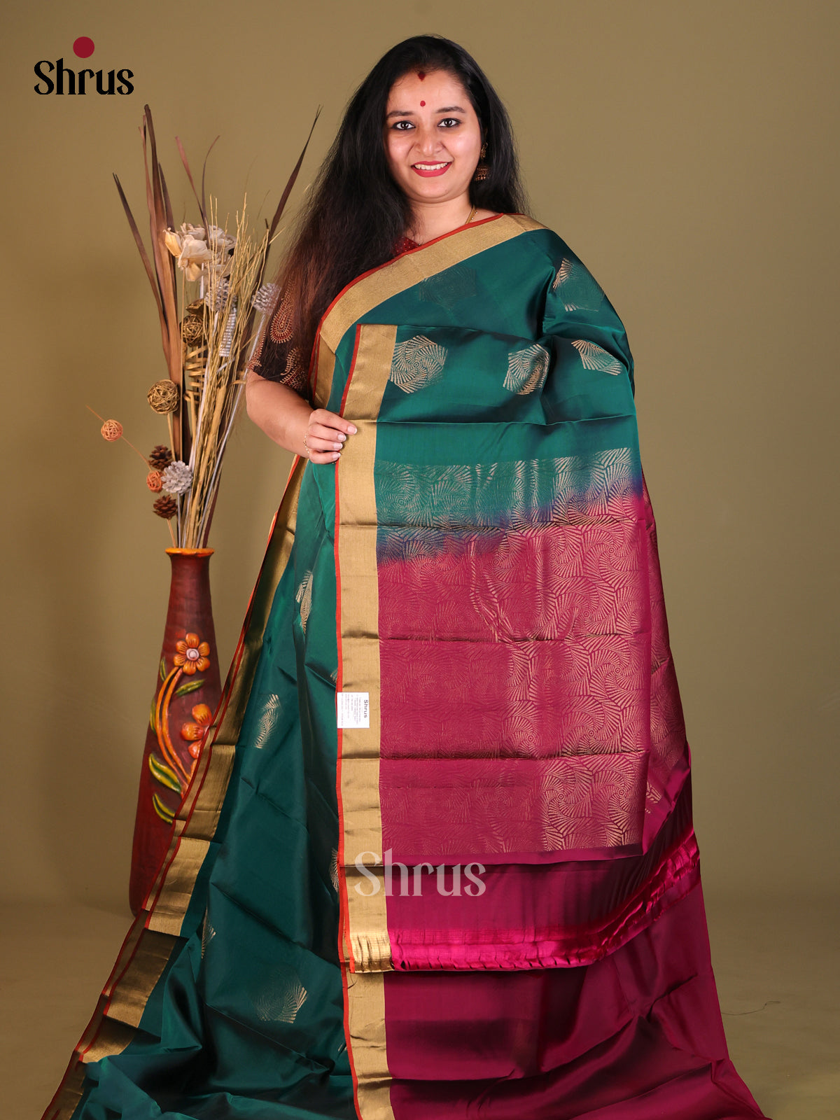 Green & Maroon Softsilk-halfpure Saree gleams with zari motifs