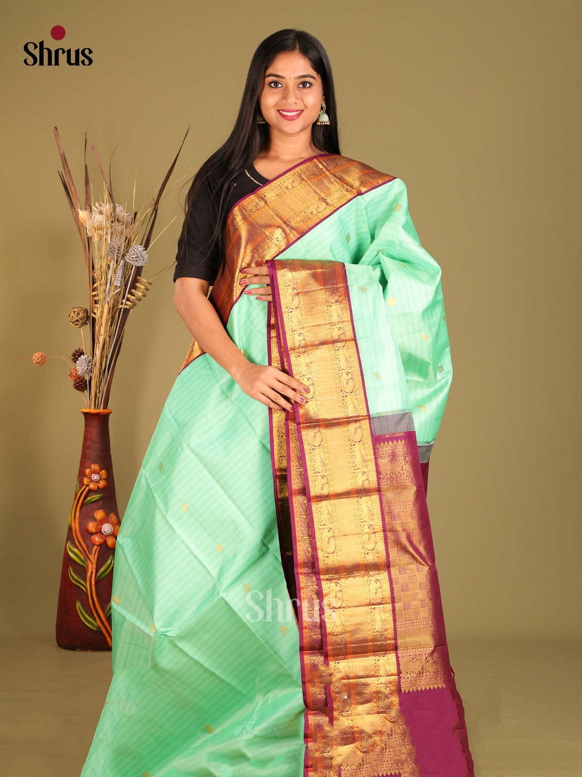 Sheeny Pastel Green Kanchipuram Silk Saree with gold peacock buttas & Maroon Zari Border