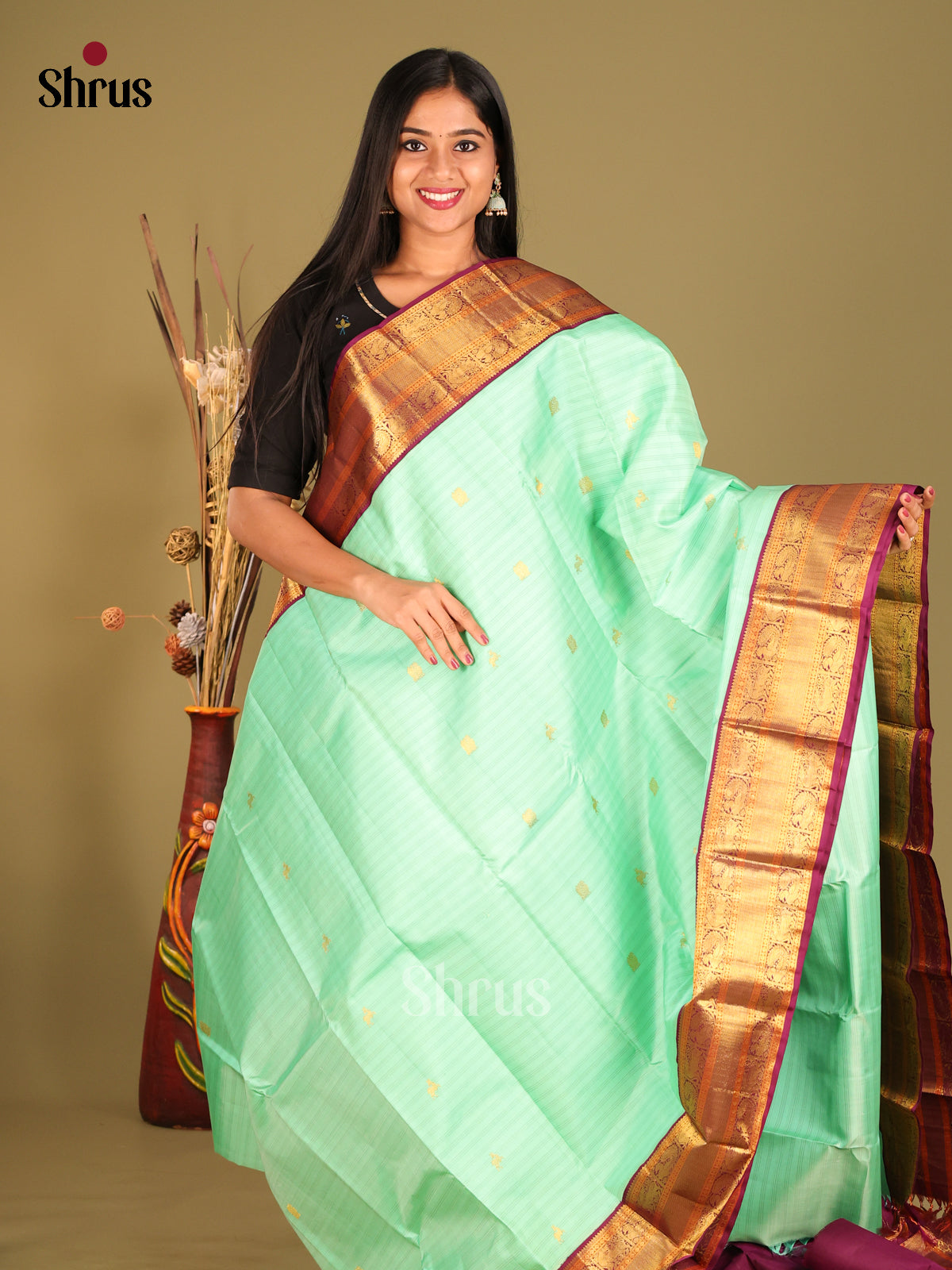 Sheeny Pastel Green Kanchipuram Silk Saree with gold peacock buttas & Maroon Zari Border 1