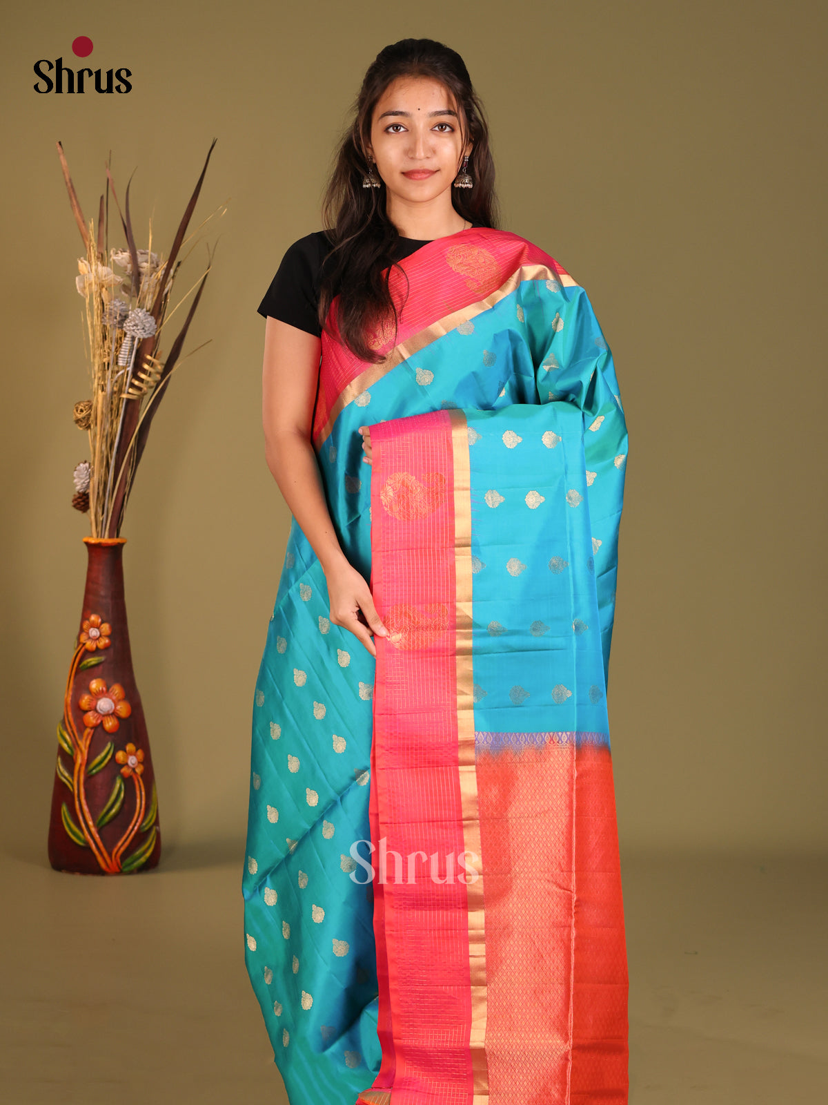 Blue & Orangish Pink Soft Silk Saree gleams with zari floral buttas