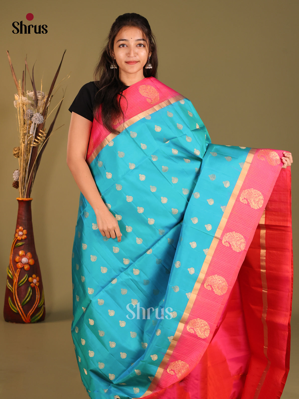 Blue & Orangish Pink Soft Silk Saree gleams with zari floral buttas