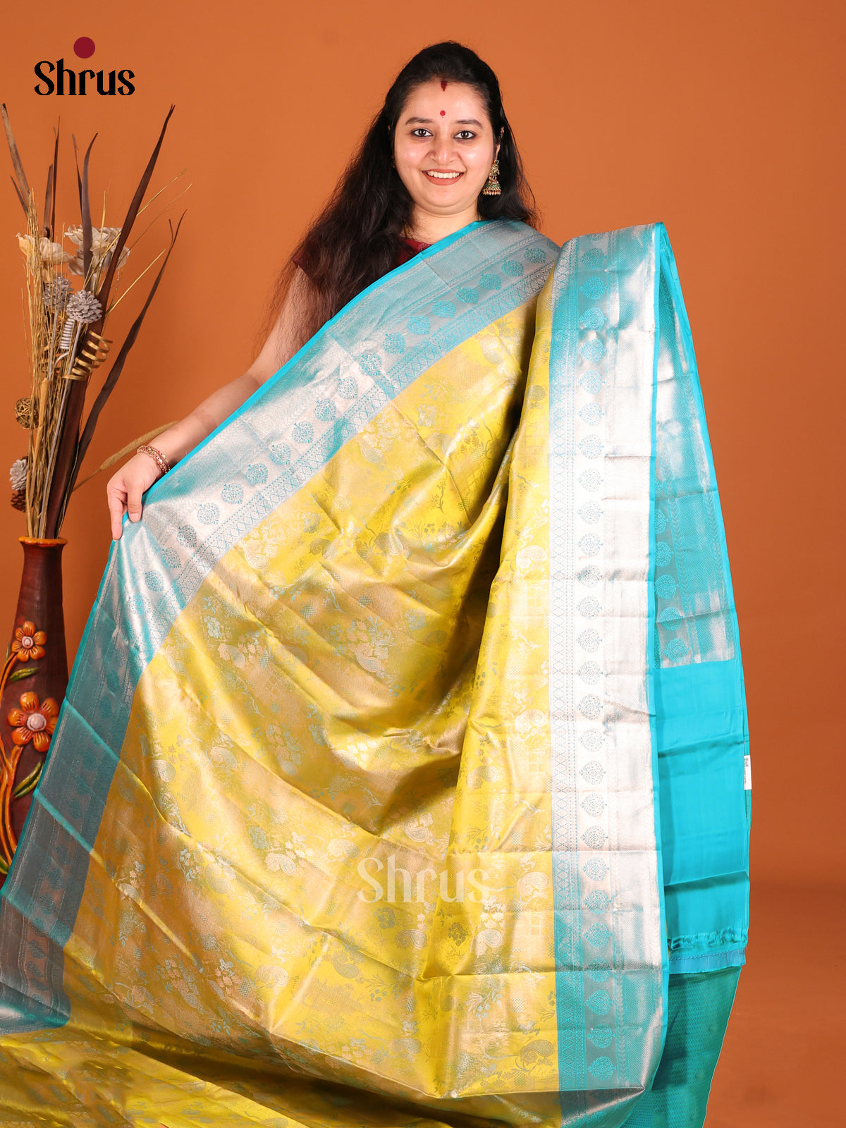 Yellow & Teal Kanchipuram silk saree dazzles with floral nestling brocade -1