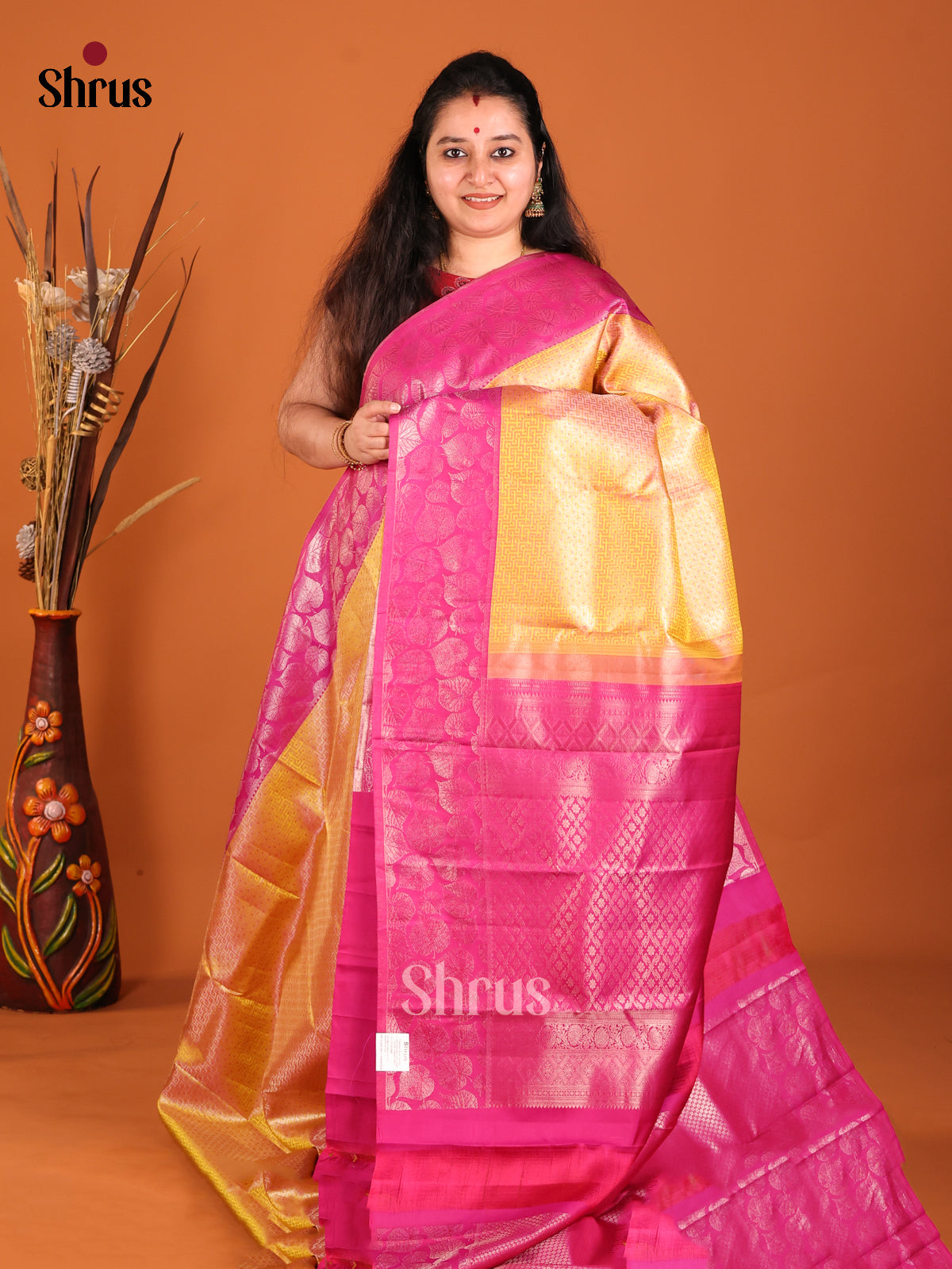 Mustard & Pink Kanchipuram silk saree gleams with leaf buttas in the border