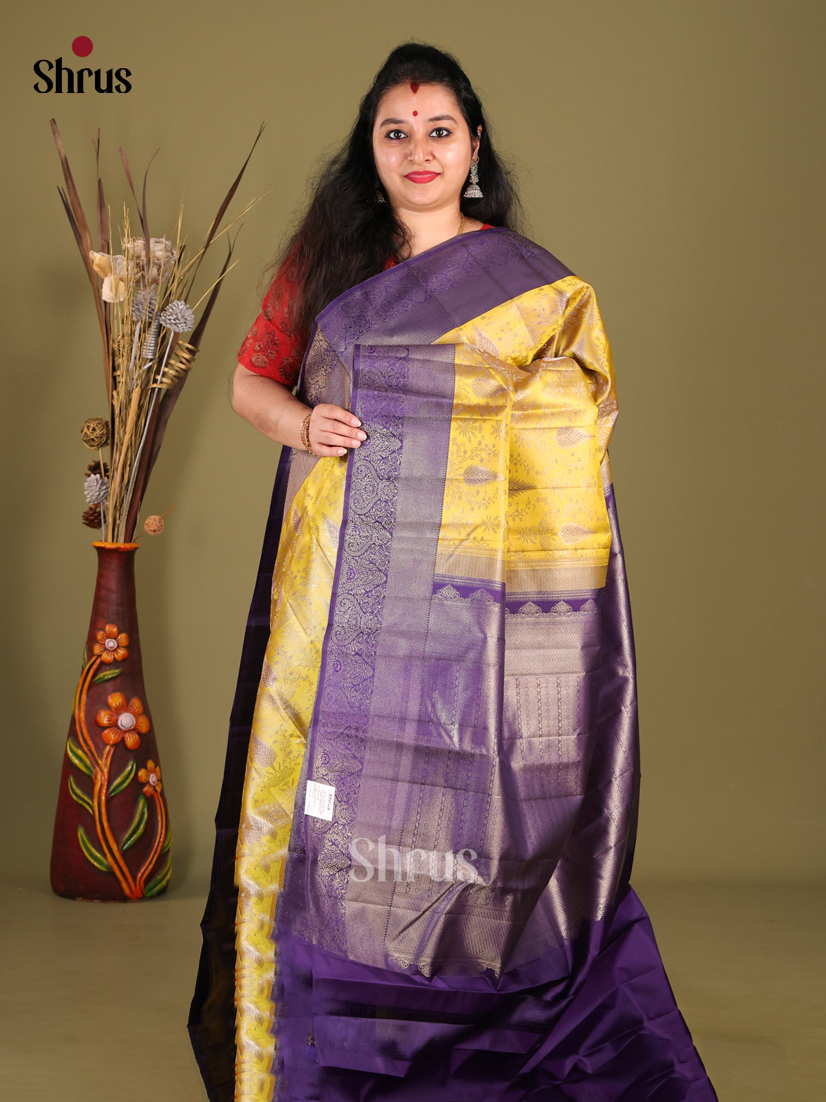 Lustrous Yellow Kanjivaram silk Saree with floral nestling brocade & Violet Border