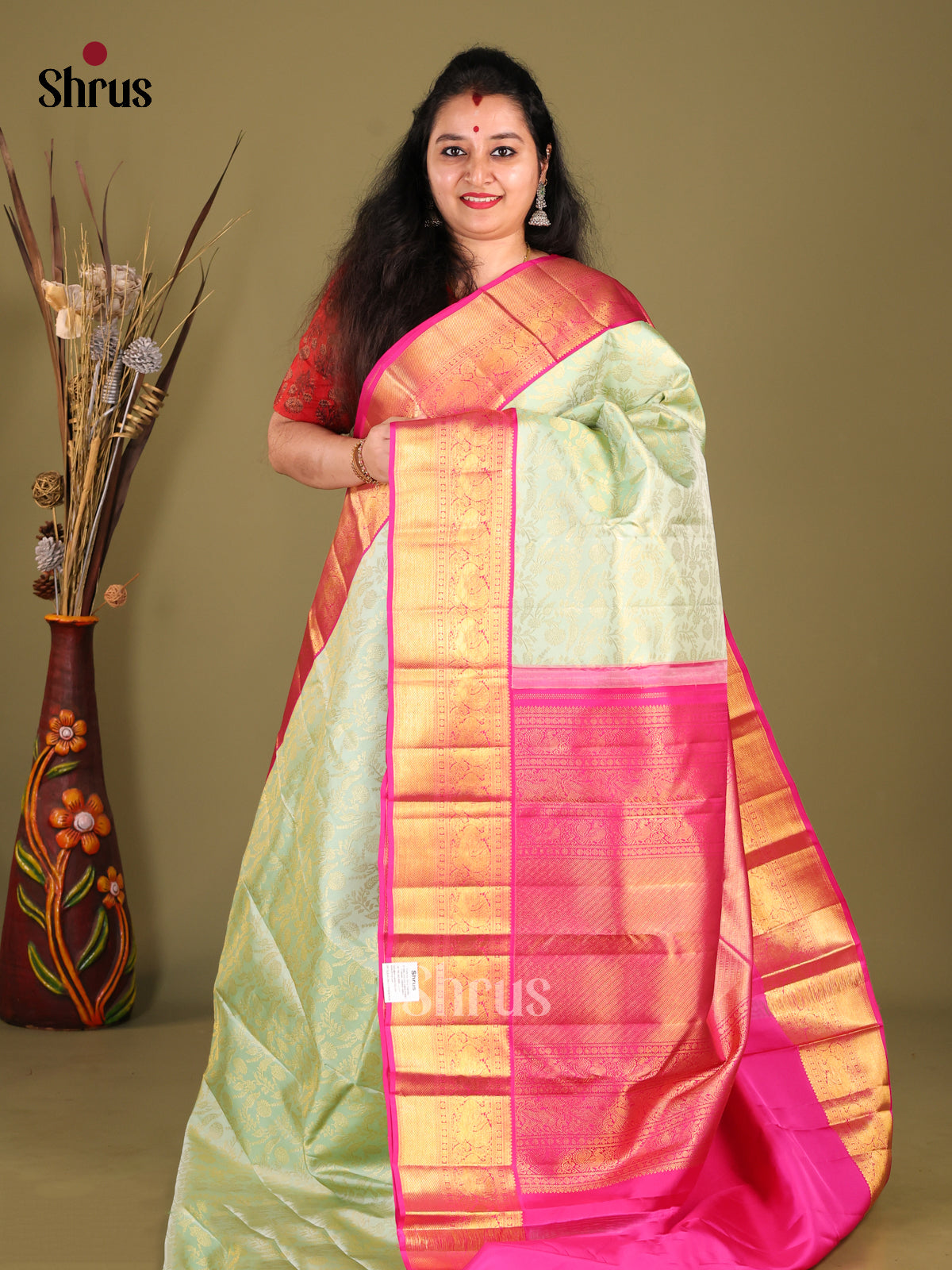 Chic Pista Green Kanjivaram Saree with floral nestling brocade & Pink Zari Border