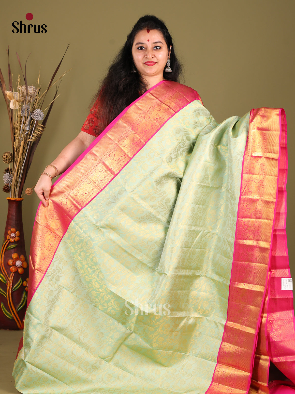 Chic Pista Green Kanjivaram Saree with floral nestling brocade & Pink Zari Border -1