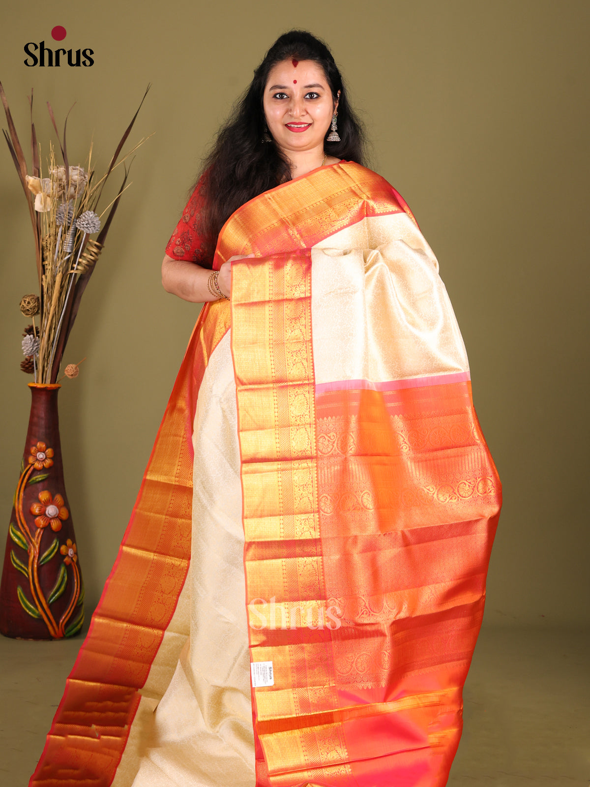 Timeless Cream Kanchipuram silk Saree with Floral Nestling Brocade & Orange zari border