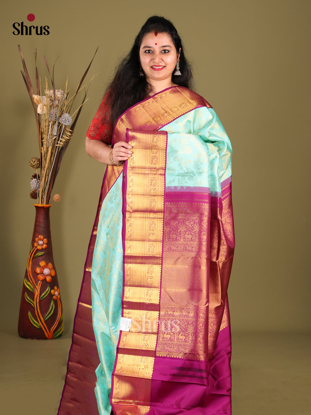 Artisanal Pastel Blue Kanchipuram Saree with Golden floral nestling brocade & Purple Border