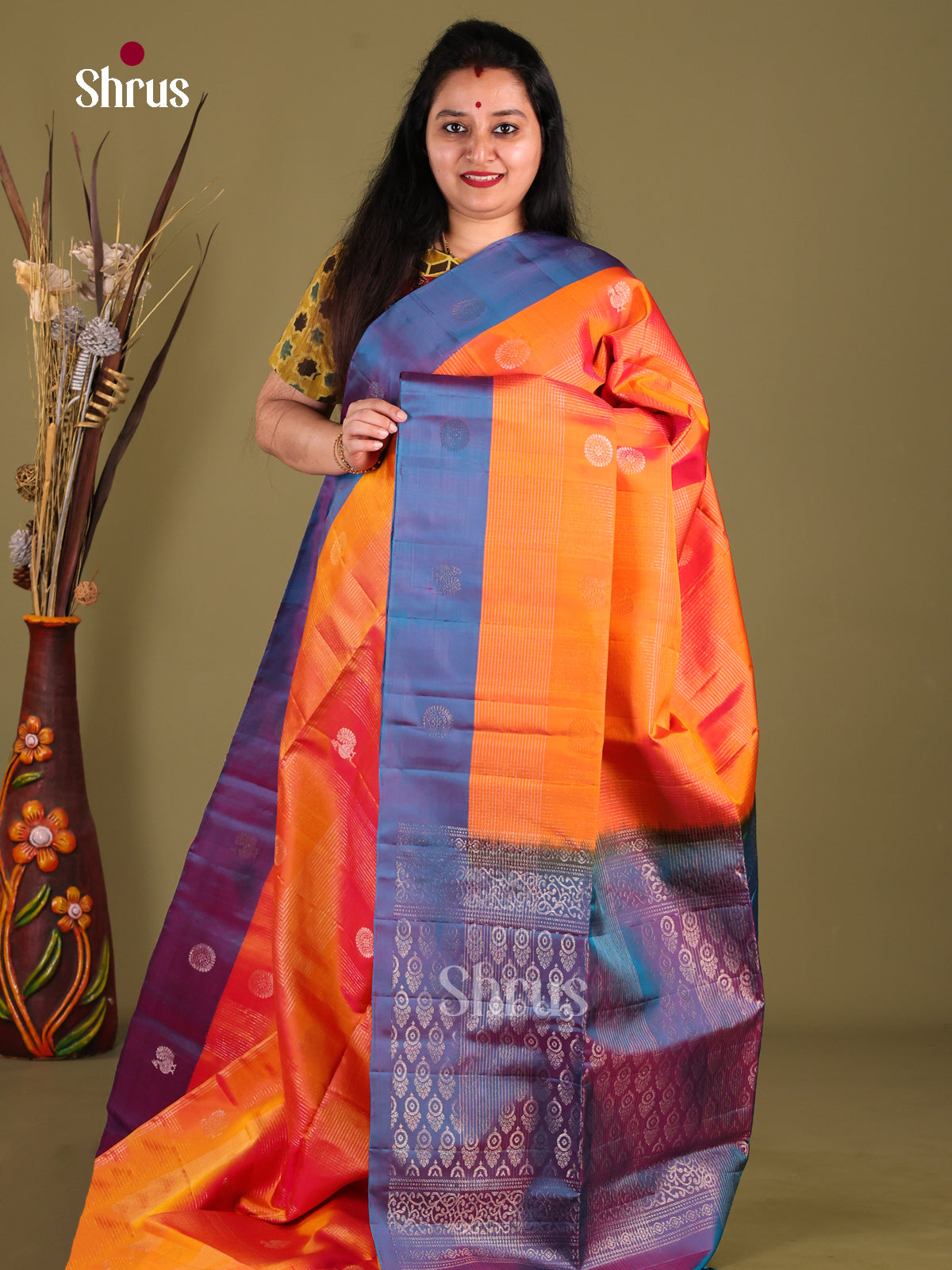 Radiant Orange Soft Silk Saree with peacock & floral buttas adorned With Brocade Pallu