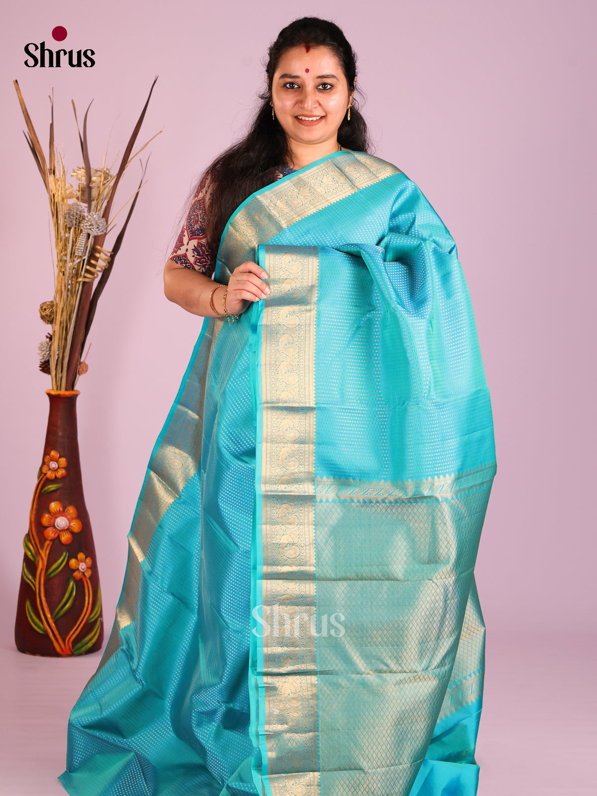 Sky Blue Single Tone Kanchipuram Butta design Saree with peacock floral vines zari border