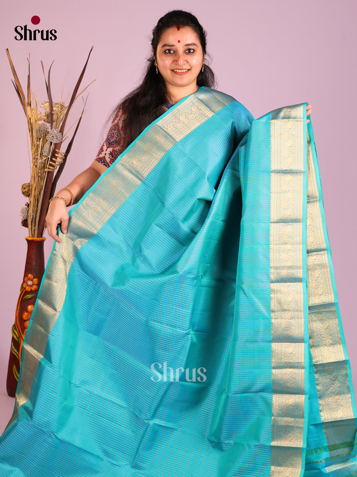 Sky Blue Single Tone Kanchipuram Butta design Saree with peacock floral vines zari border
