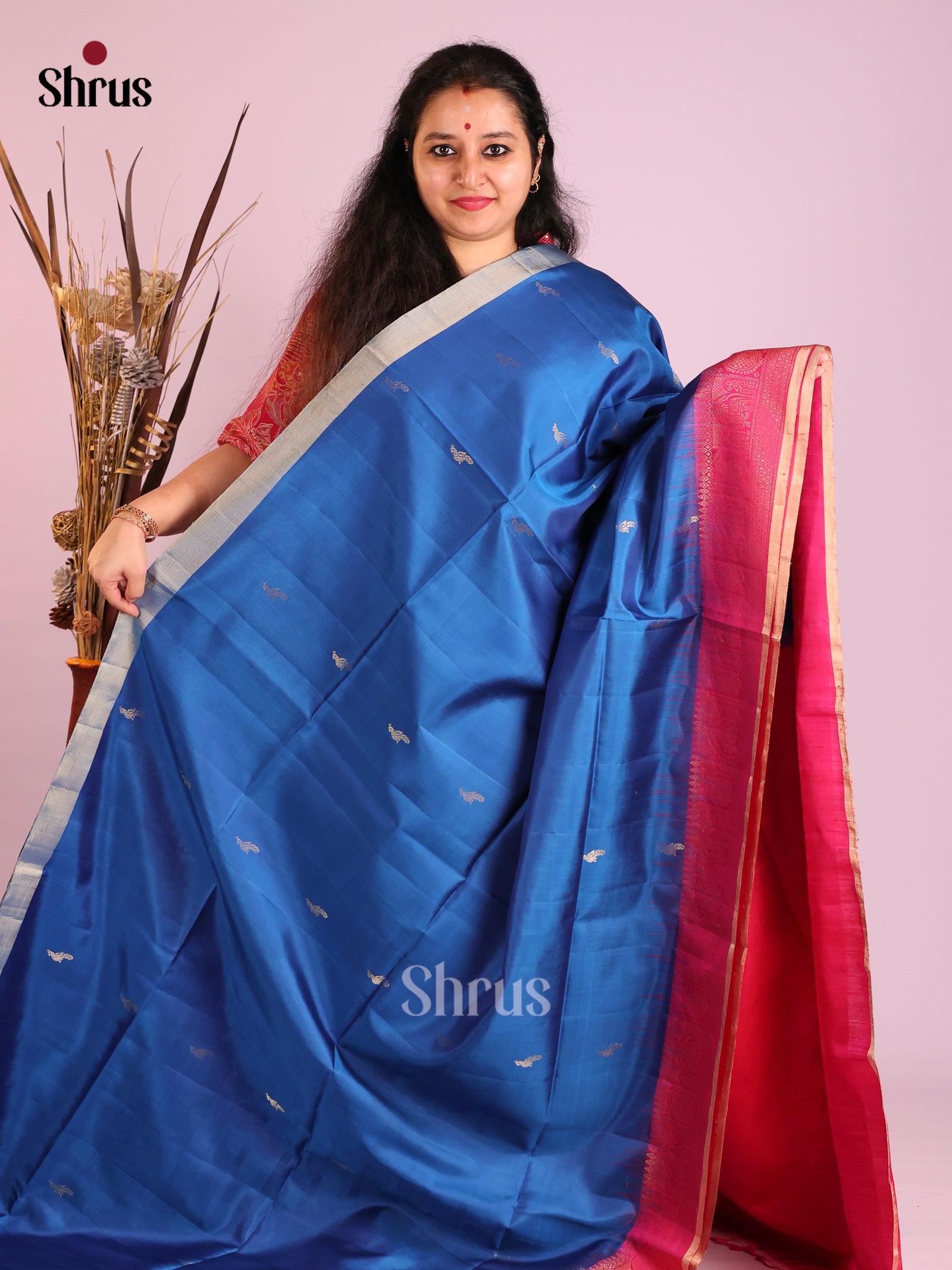 Vibrant blue Soft Silk Saree gleams with zari peacock buttas 1