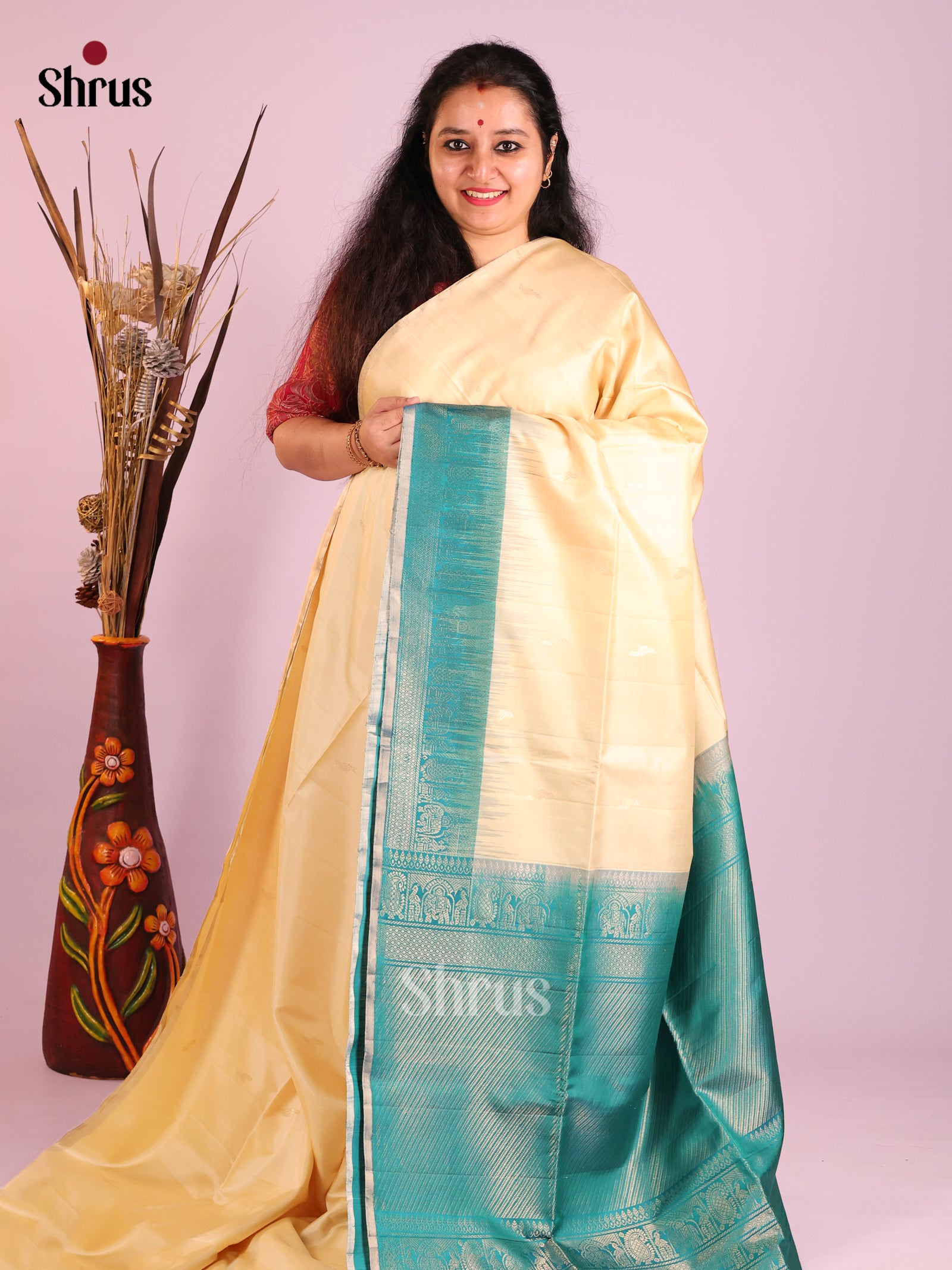 Enchanting Cream Soft Silk Saree with Teal zari border With elephant buttas