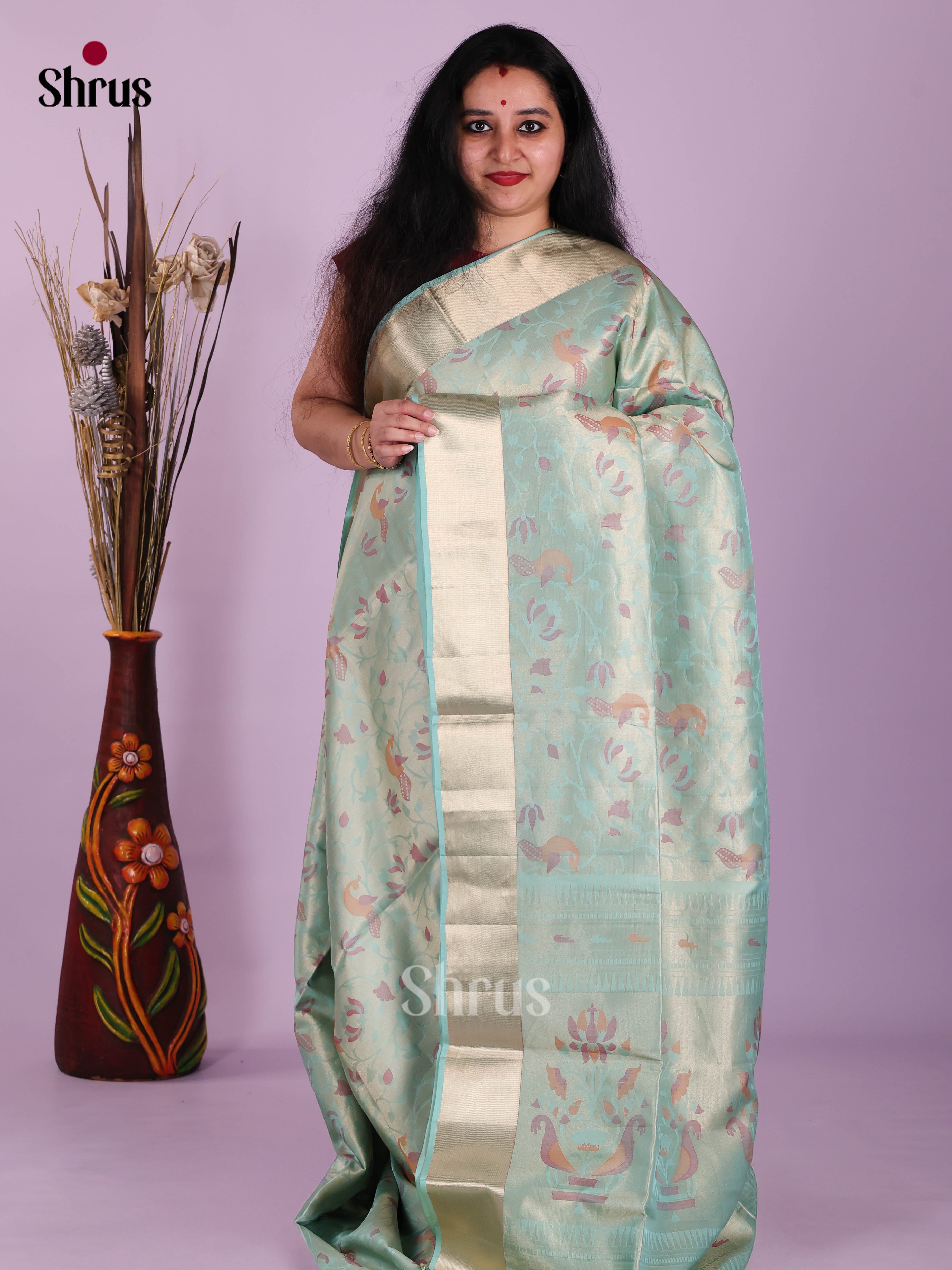 Stunning Ice Blue Soft Silk Saree with floral nestling brocade & Kaddi Border