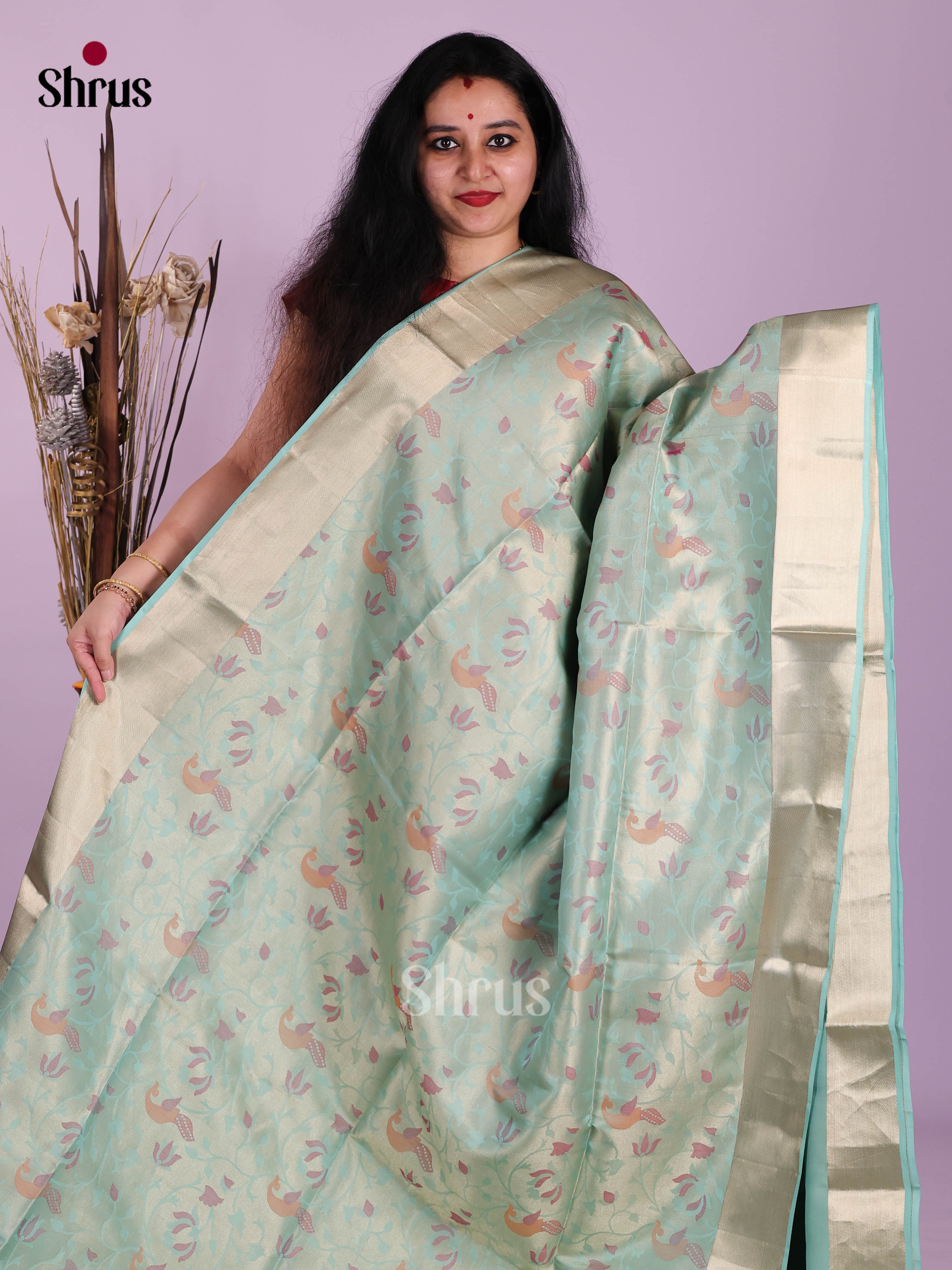 Stunning Ice Blue Soft Silk Saree with floral nestling brocade & Kaddi Border