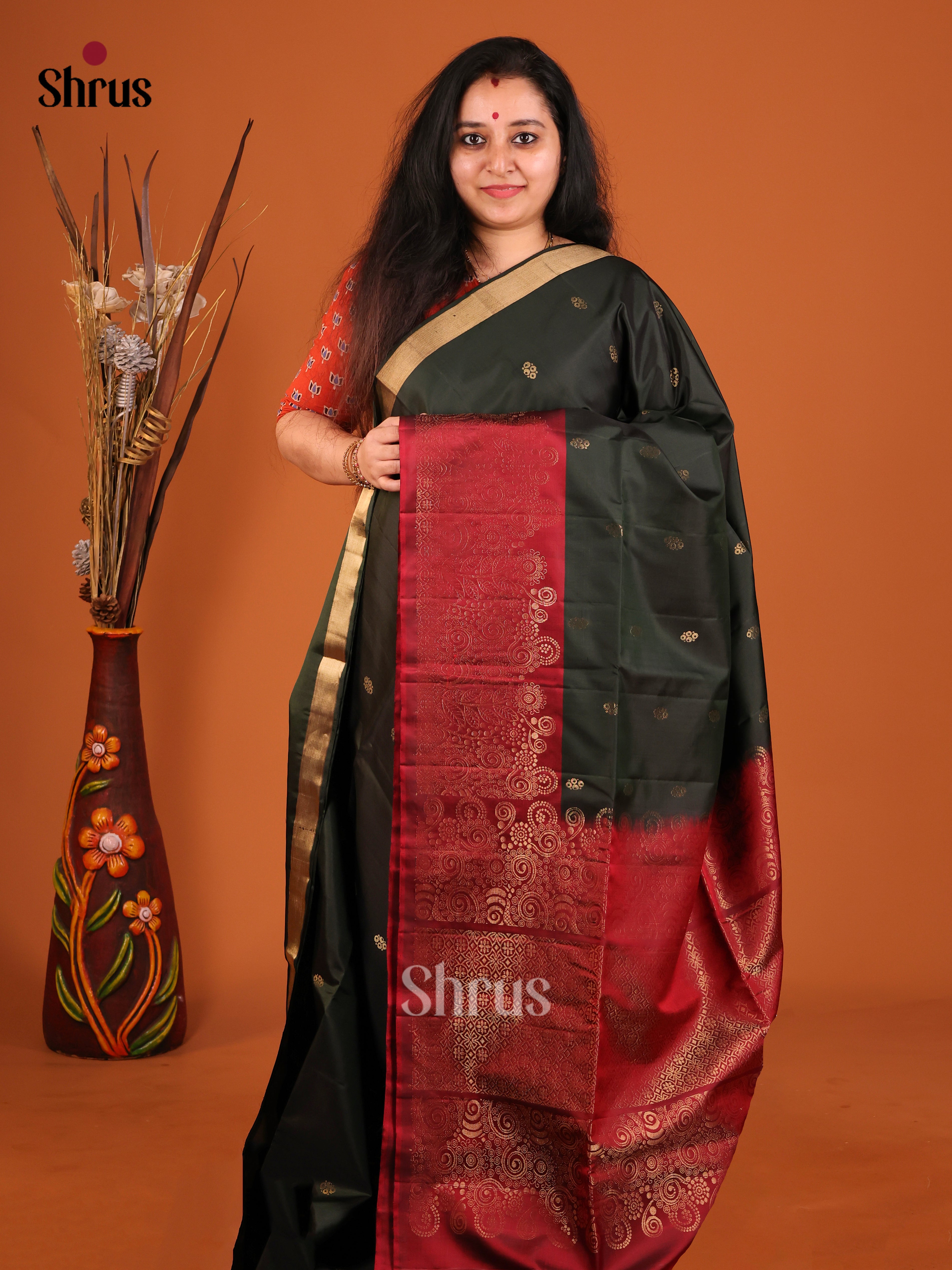 Stunning Dark Green Soft Silk Saree adorned with Gold Buttas & Maroon brocade border