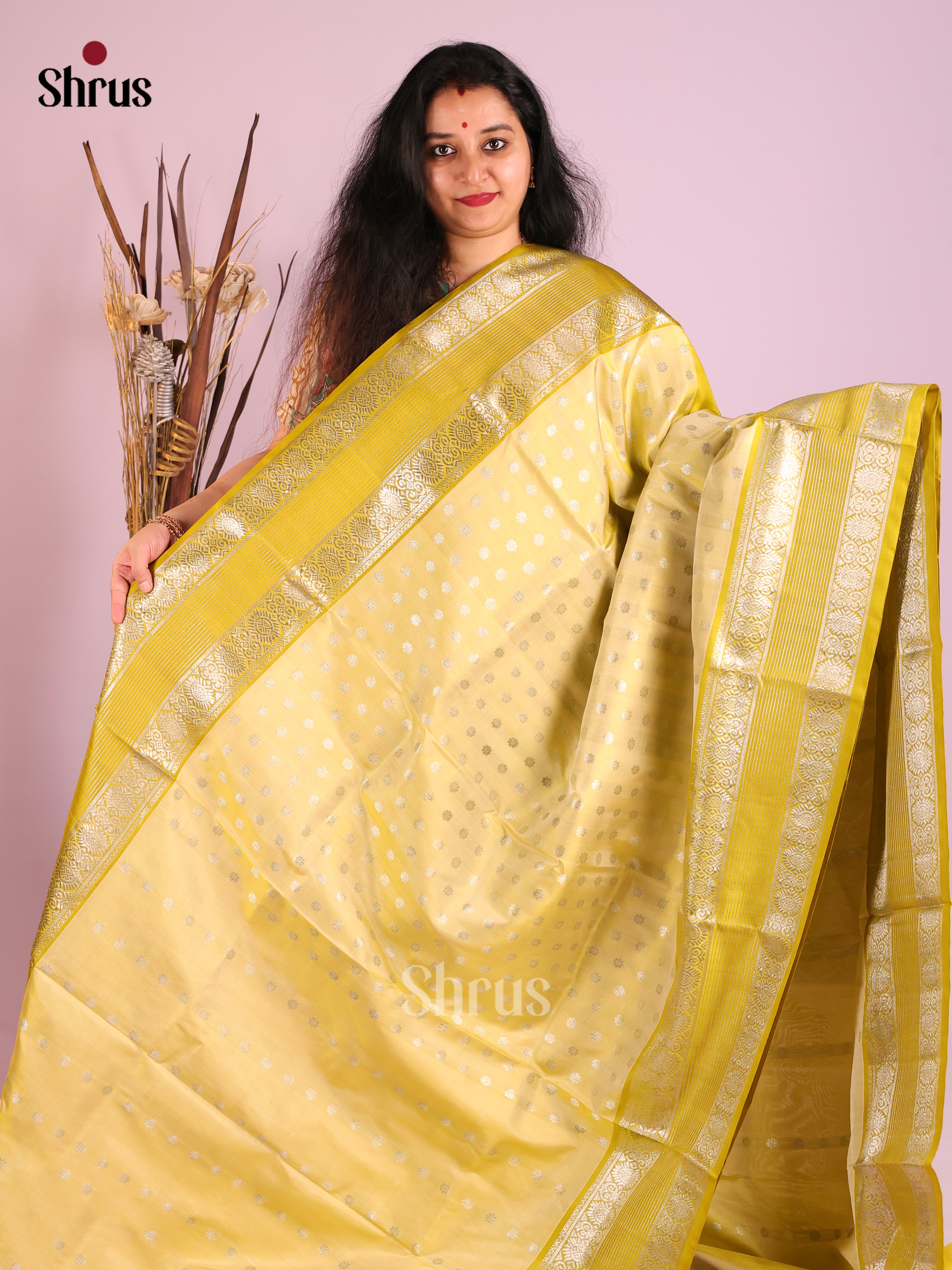 Light Yellow single Tone Venkatagiri silk Saree gleams with zari buttas , rettaipet border