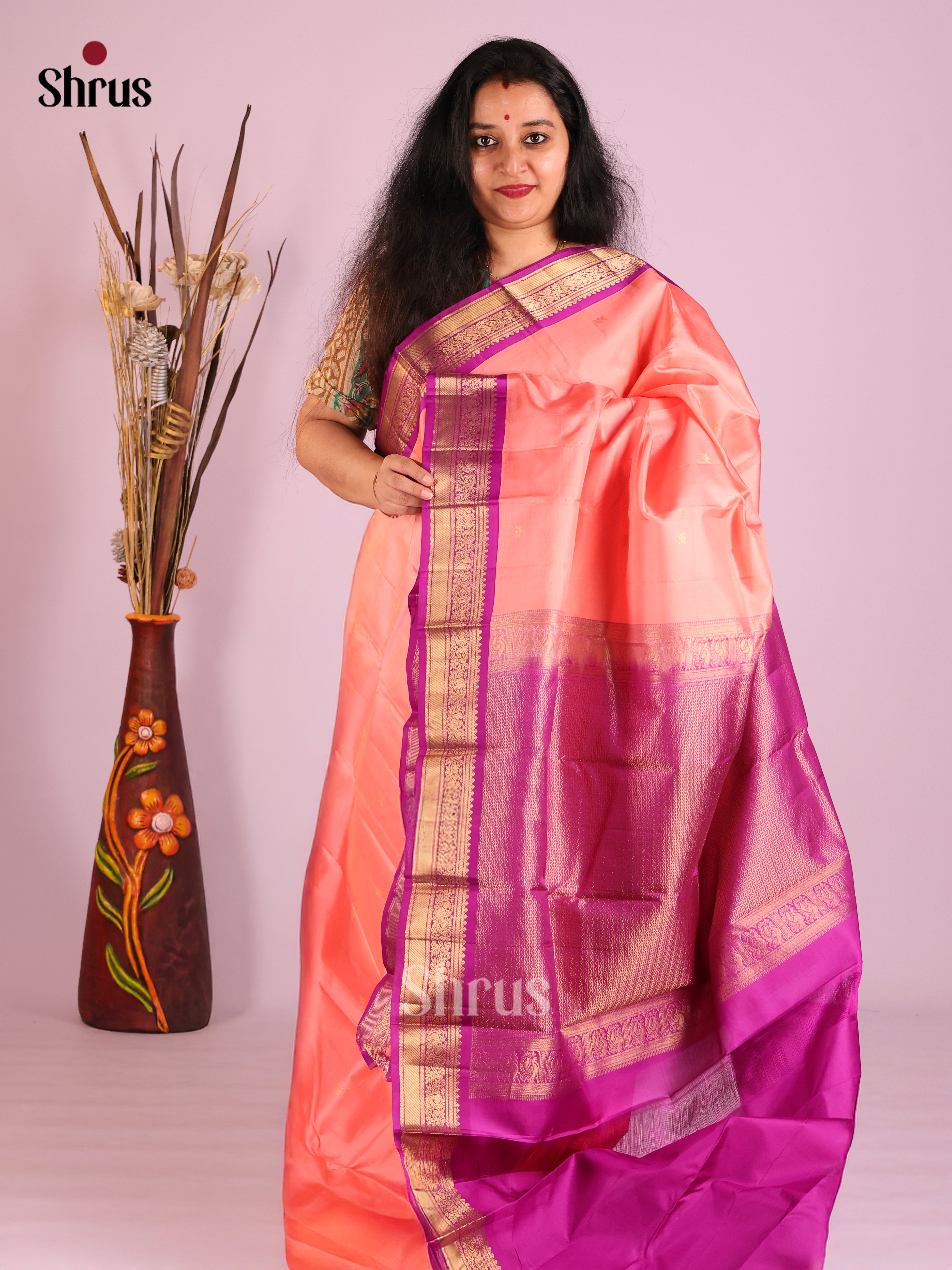 Radiant Peach Kanjivaram Saree with gold floral buttas & Purple Brocade Pallu