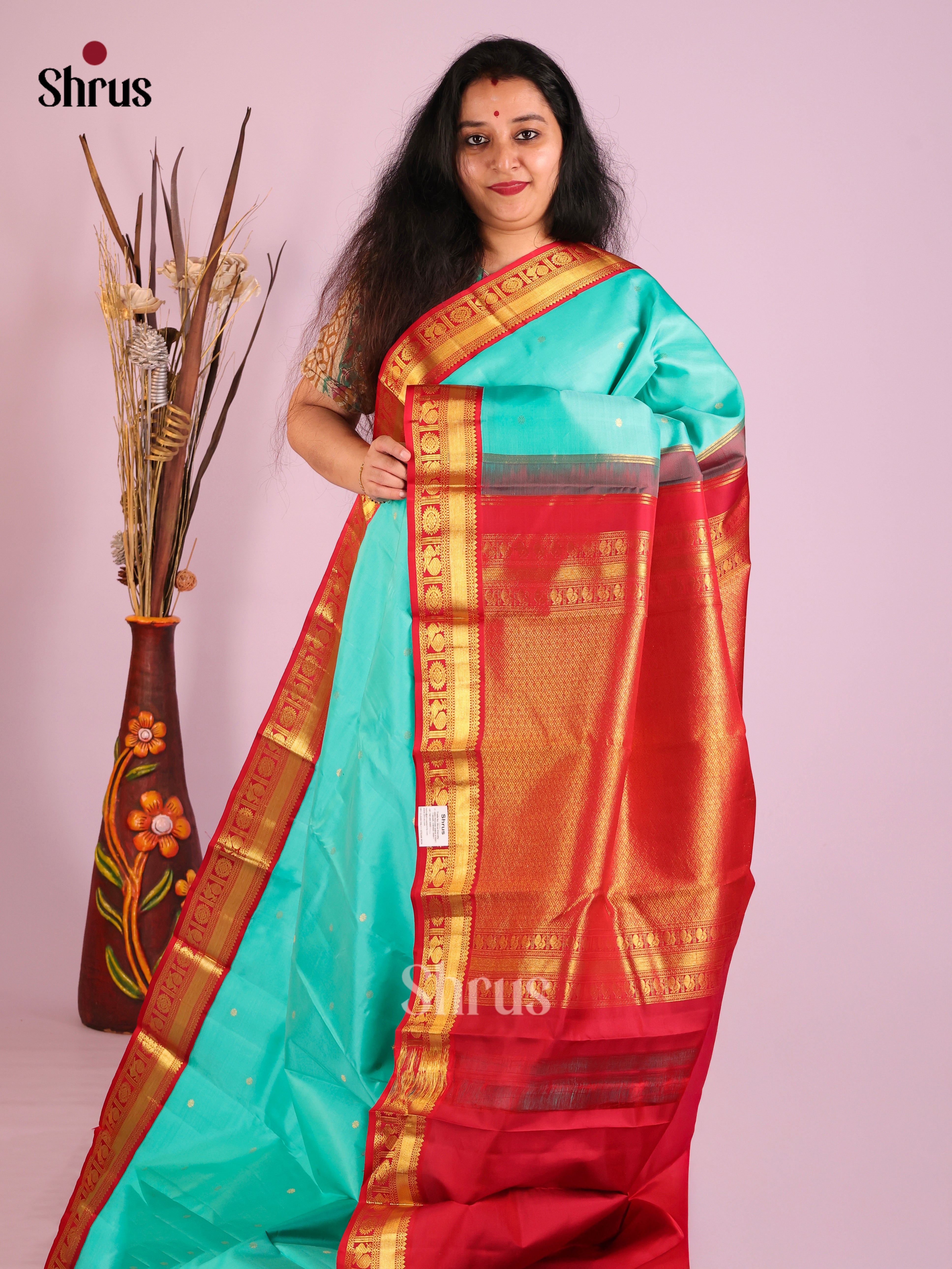 Luxurious Rama Blue Kanjivaram Saree with Golden Buttas & rich Red zari brocade pallu